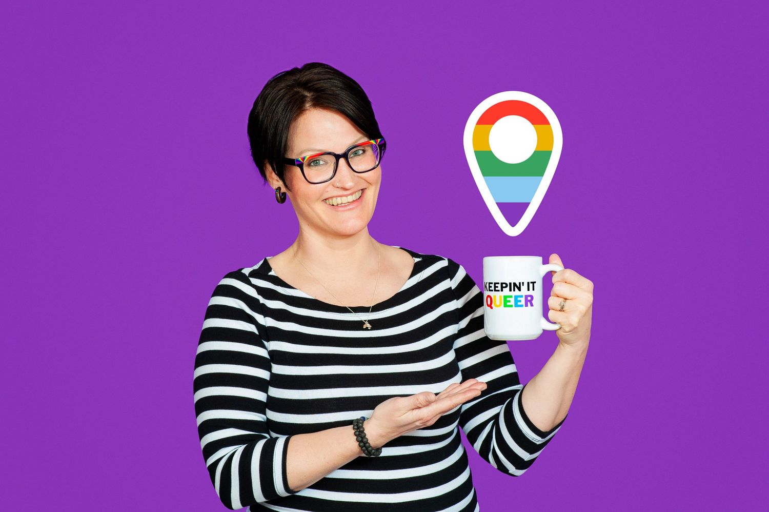 Woman in striped shirt holding a mug with rainbow pride location pin graphic on purple background.