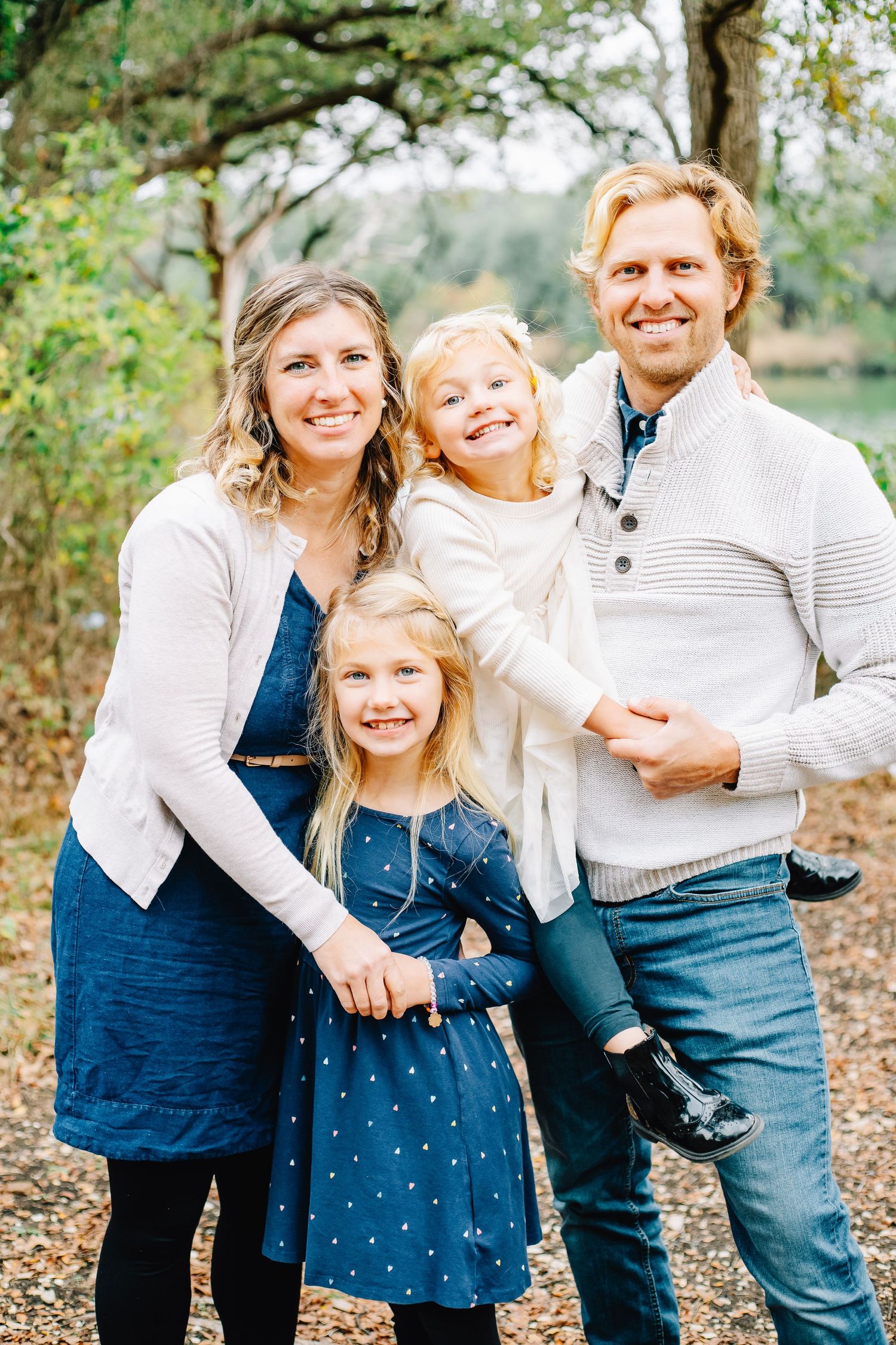 Happy family sharing joyful moments together in a natural outdoor setting.