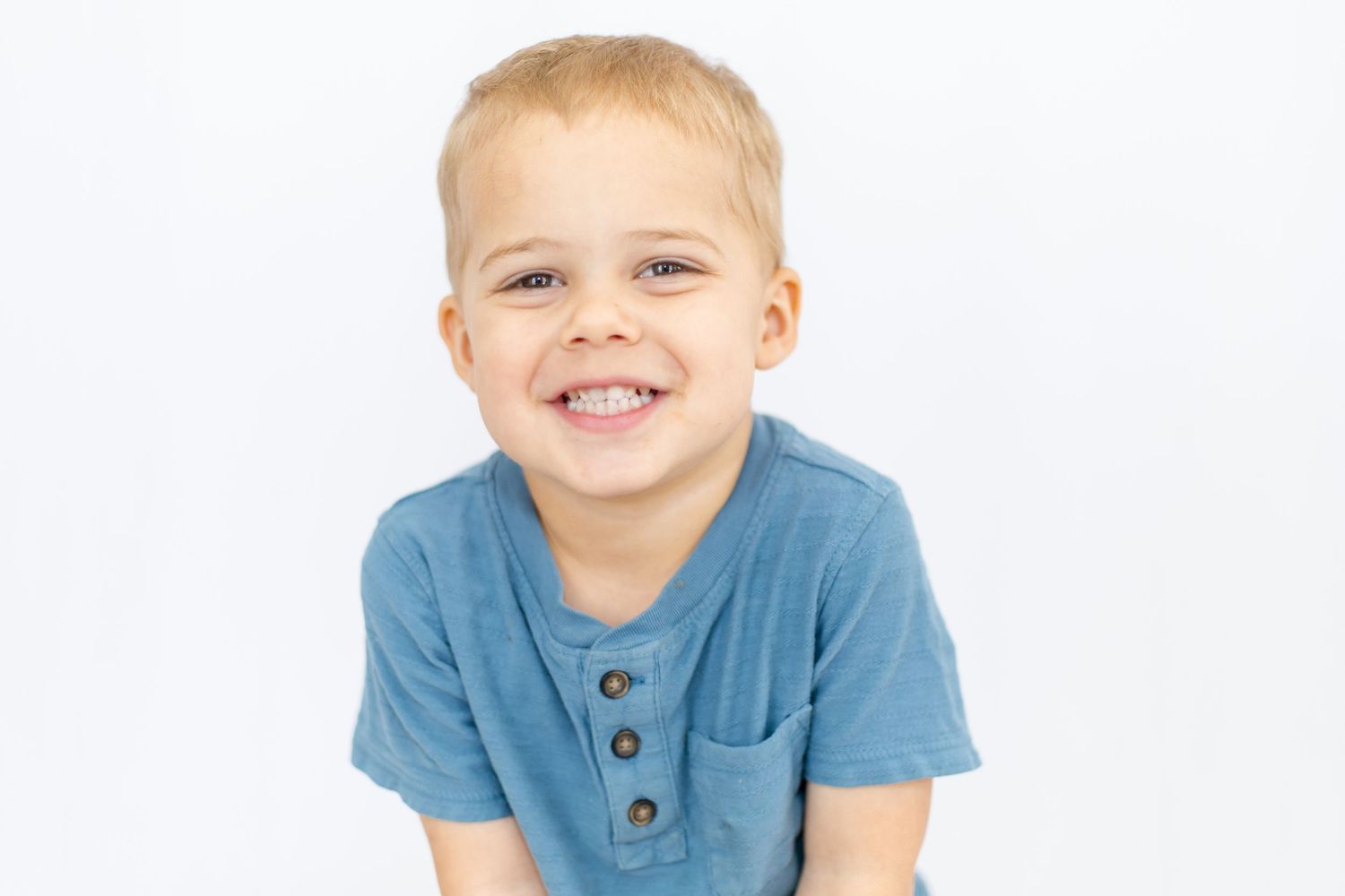 Casual portraits in blue t-shirt showing cheerful expressions.