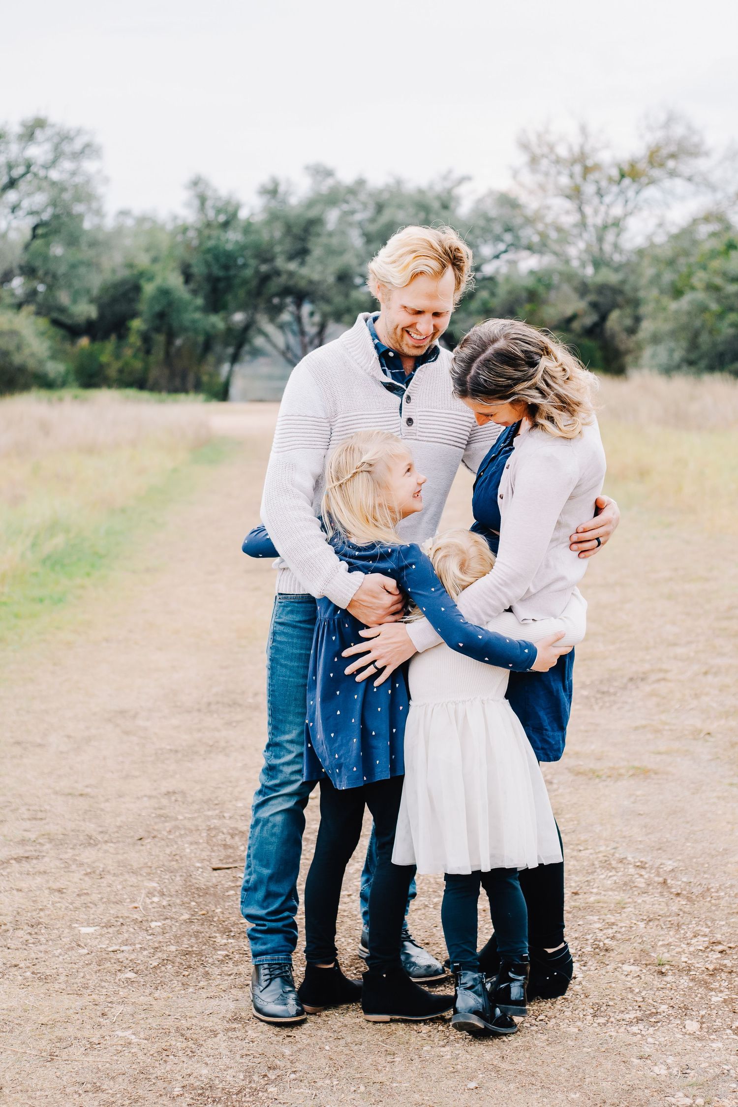 Family having fun outdoors in casual clothing on a sunny field.