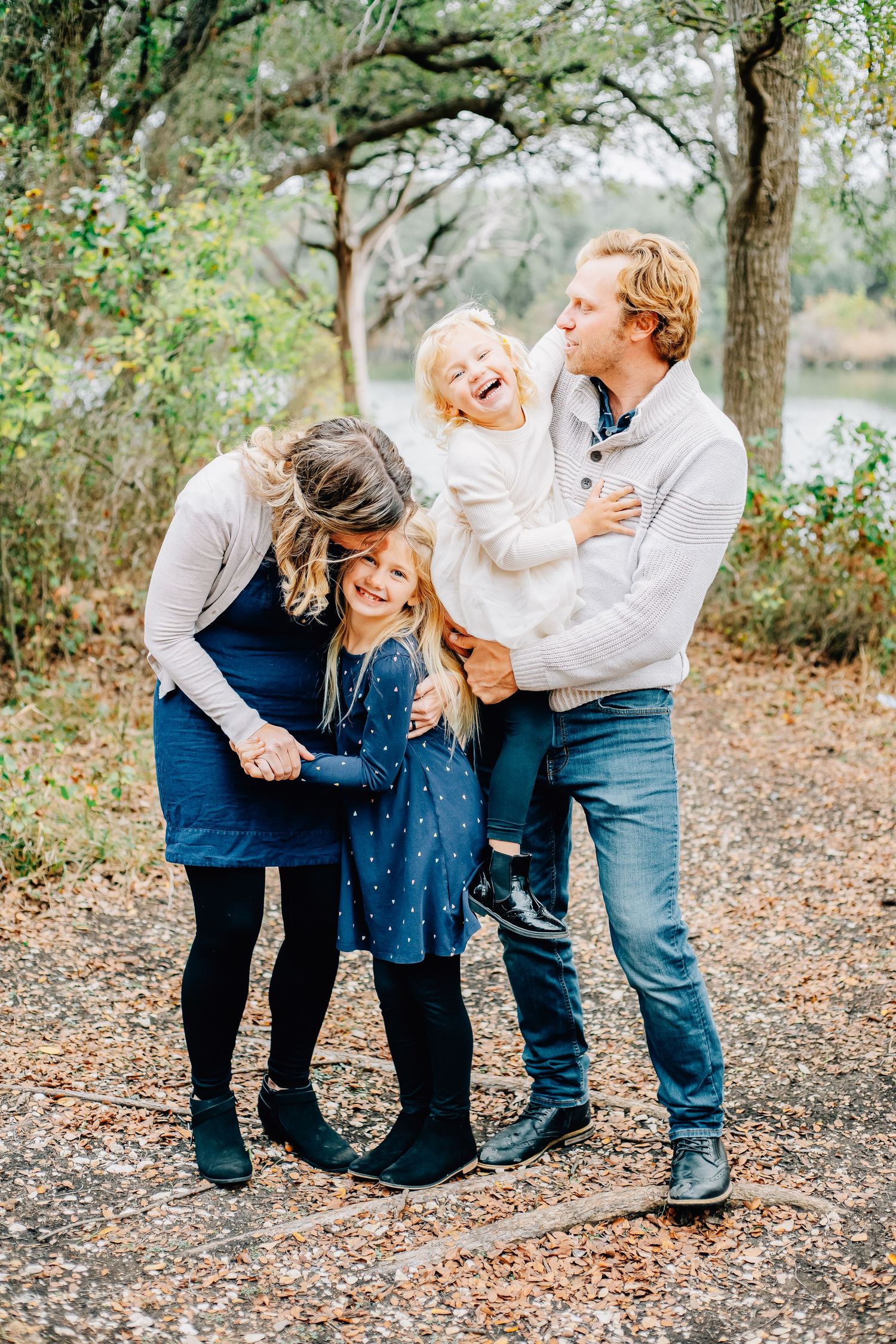 Natural family portraits showing genuine laughter and connection outdoors.