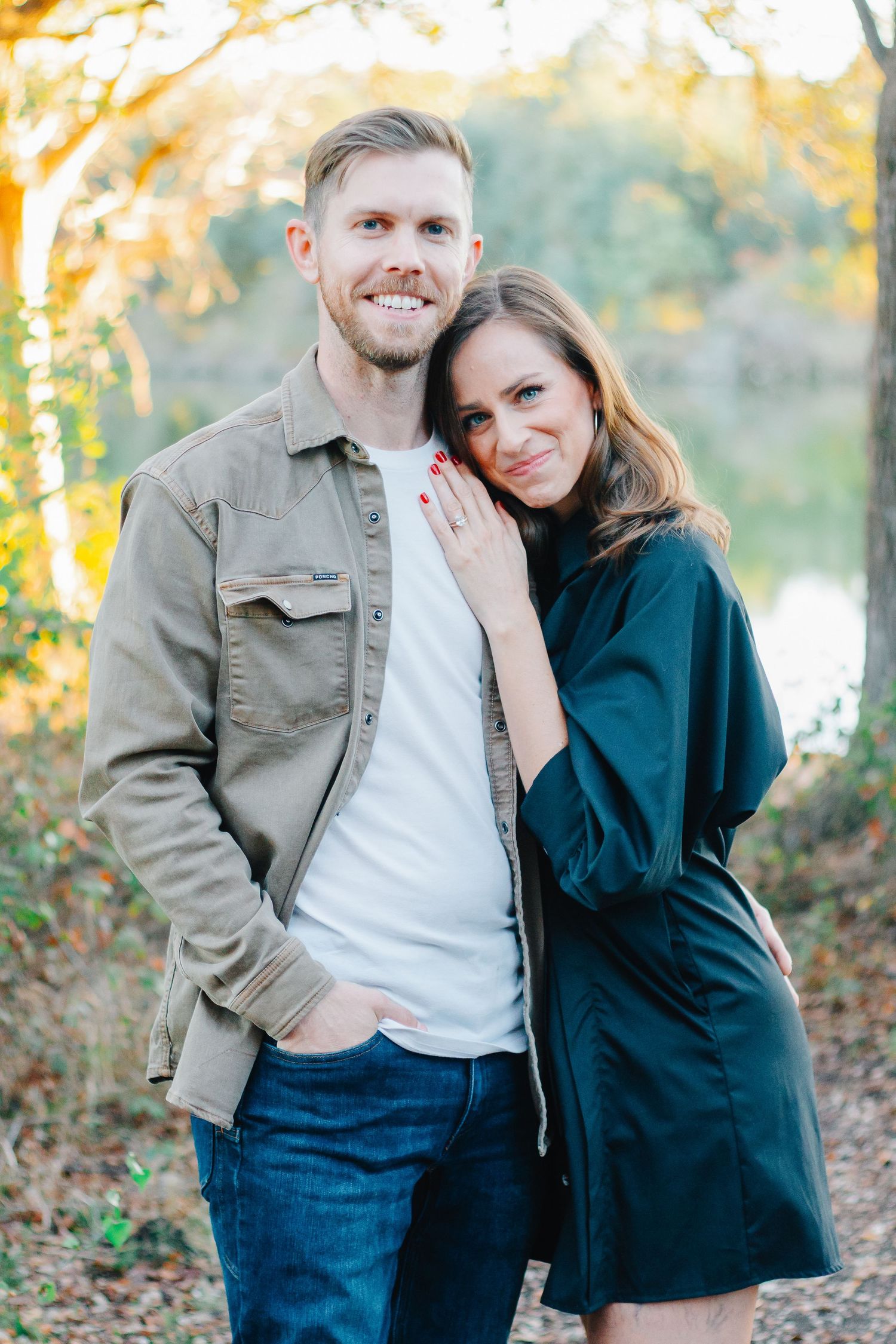 A couple shares an intimate moment outdoors during an autumn photoshoot.
