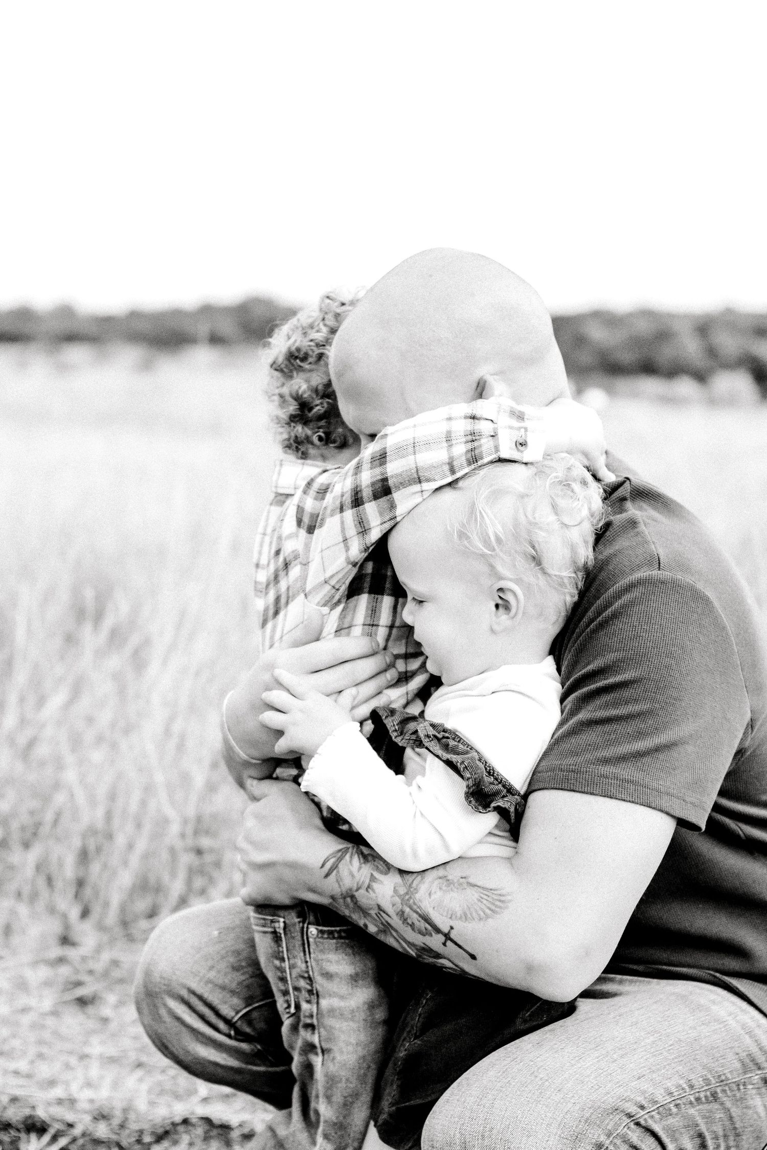 Black and white intimate portrait of parent and child embracing.