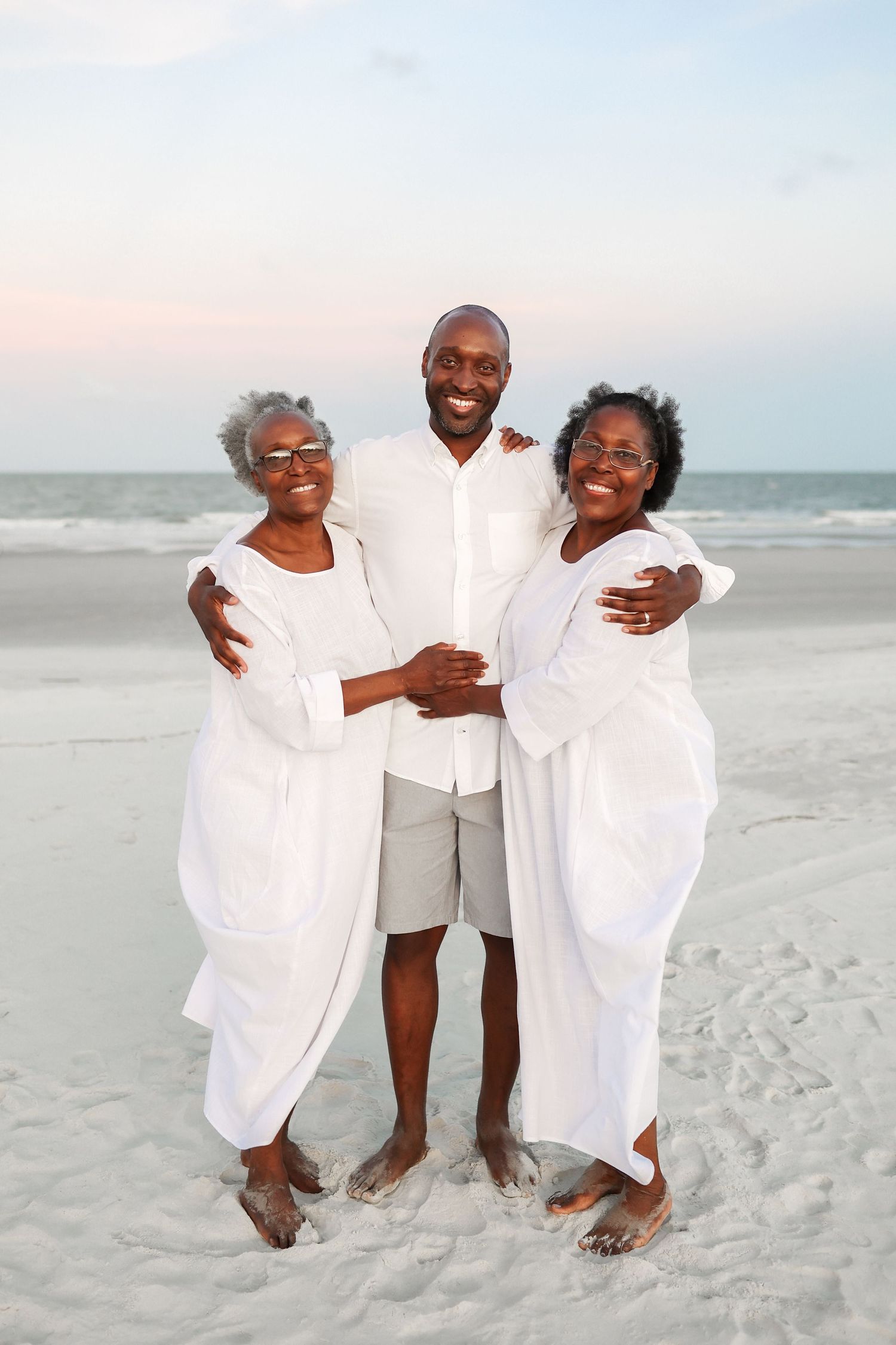 Hilton Head family photography featuring a Black man smiling with his mother and aunt during beach portraits in Palmetto Dunes