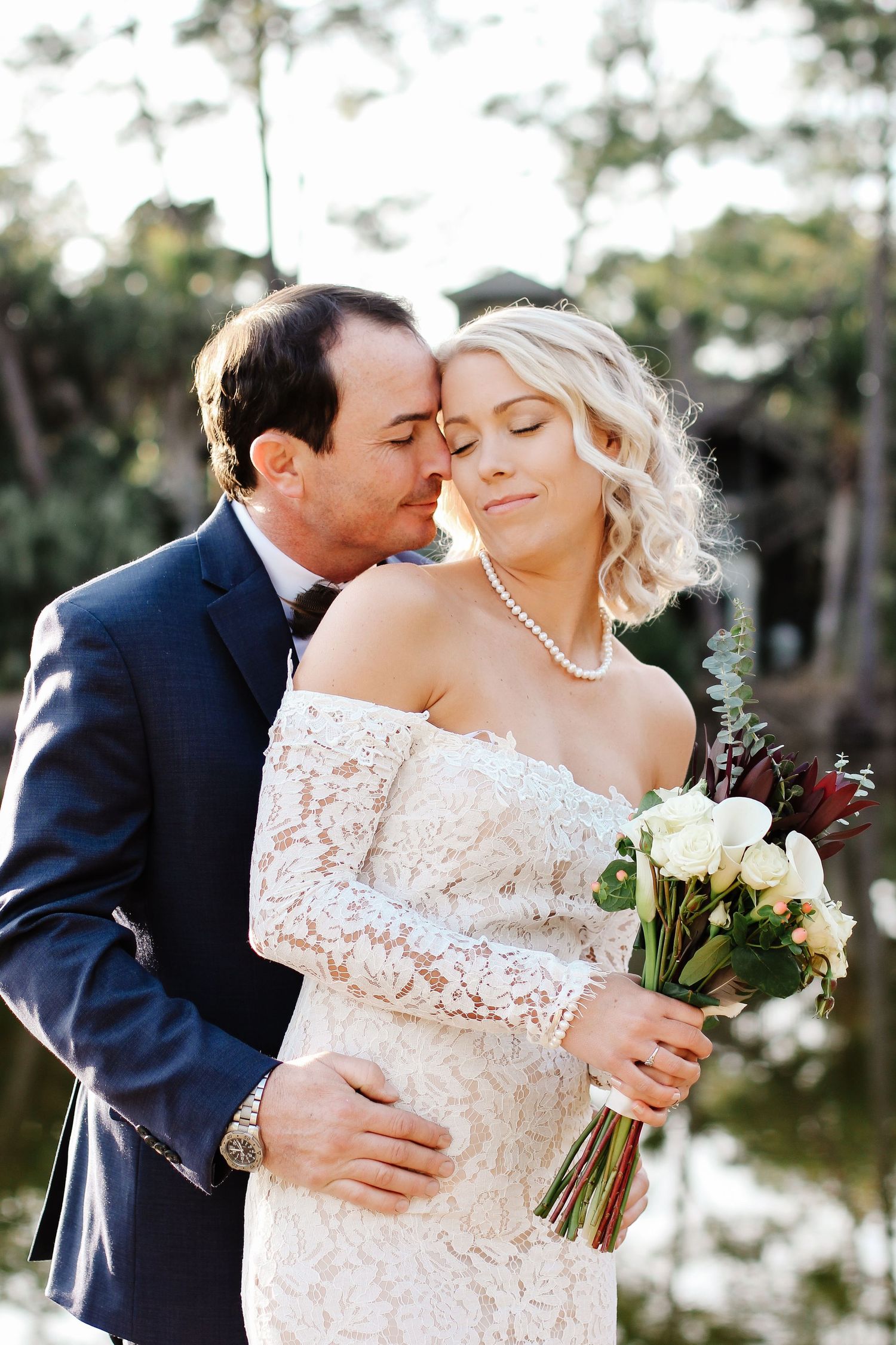 Newly married couple smiling by a lagoon during wedding photography portraits on Fripp Island, South Carolina