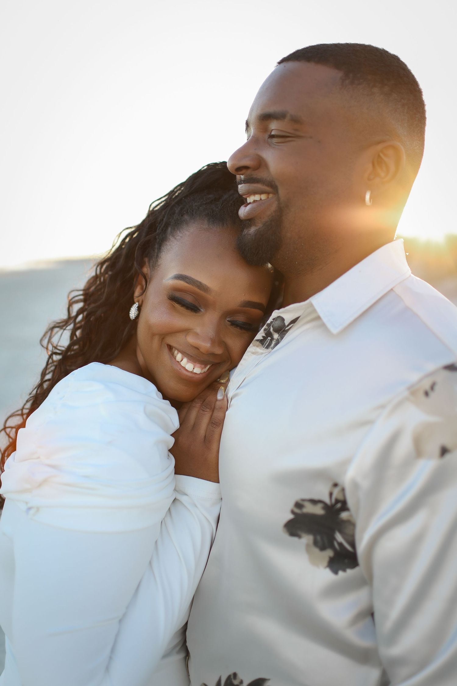 Couples photography session at sunset on Folly Field Beach, Hilton Head Island with relaxed natural posing