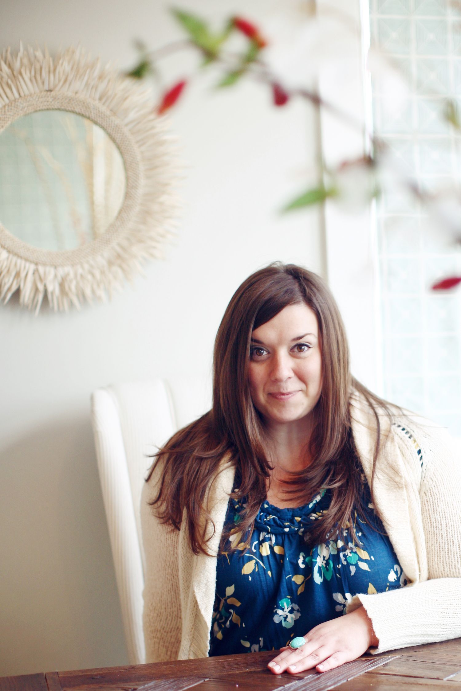 Krista Ercin-Maurer, Hilton Head photographer and founder of Island Belle Photo, smiling while seated at a table