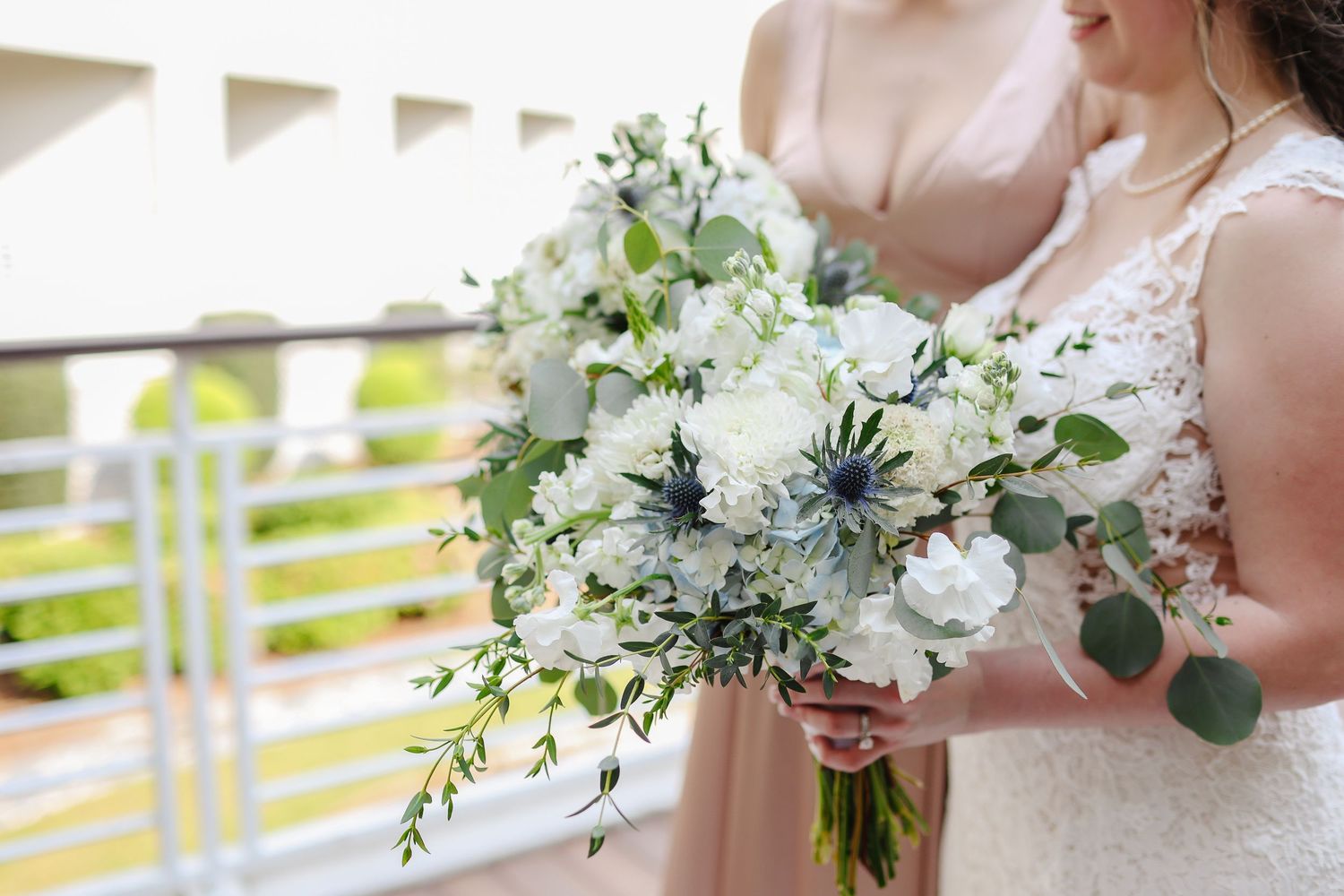 Bride and bridesmaid holding white floral bouquets during Hilton Head wedding photography portraits