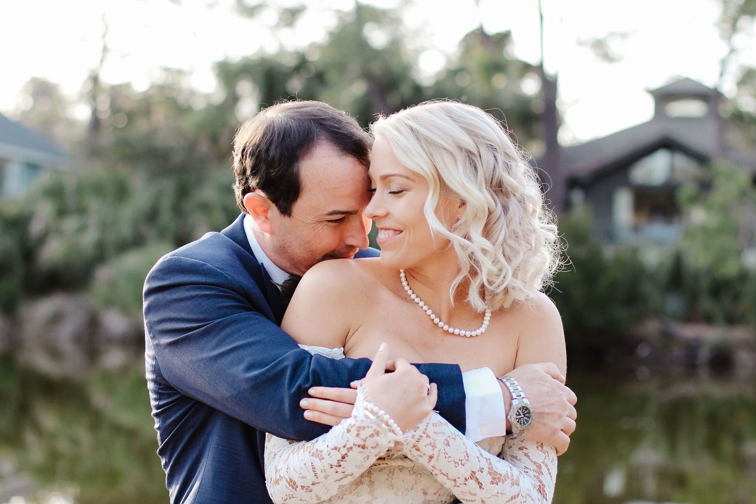 Intimate wedding and elopement photography of a couple embracing beside a lagoon on Fripp Island, South Carolina