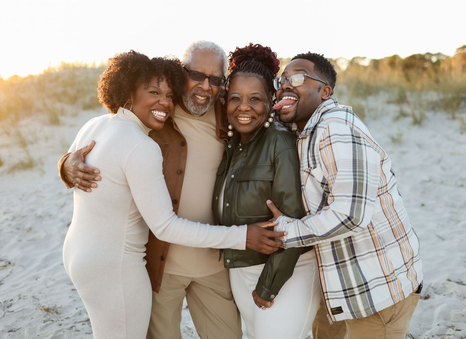 Natural family reunion photos on Hilton Head beach, adult siblings laughing and hugging during extended family session