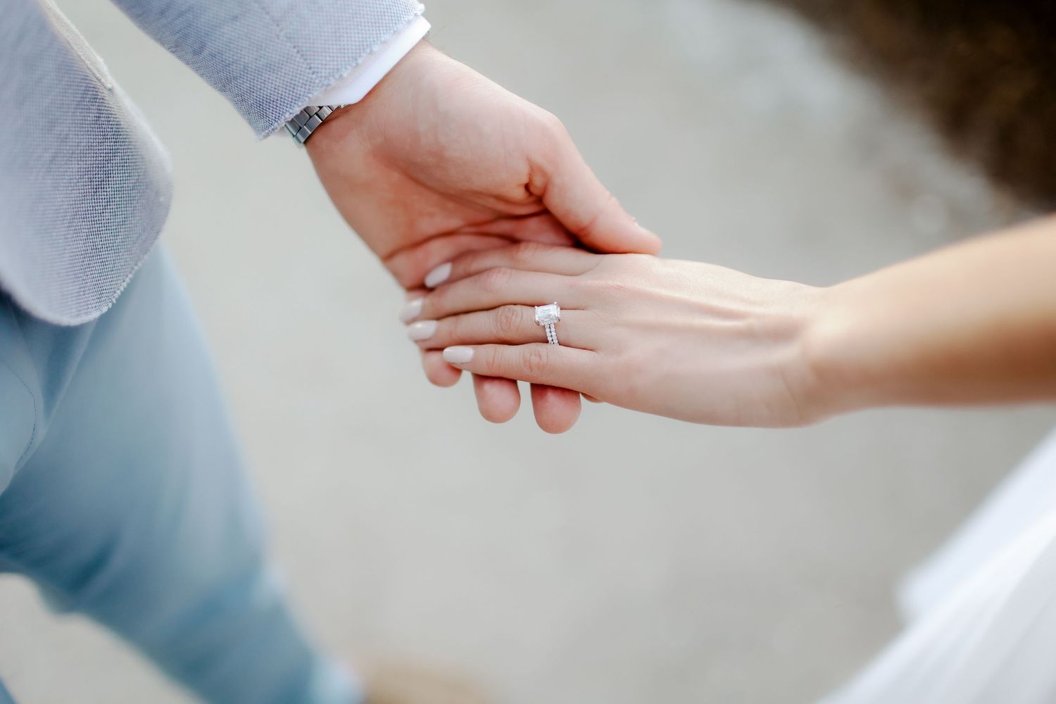 Groom holding bride’s hand to show wedding ring during elopement photography on Hilton Head Island