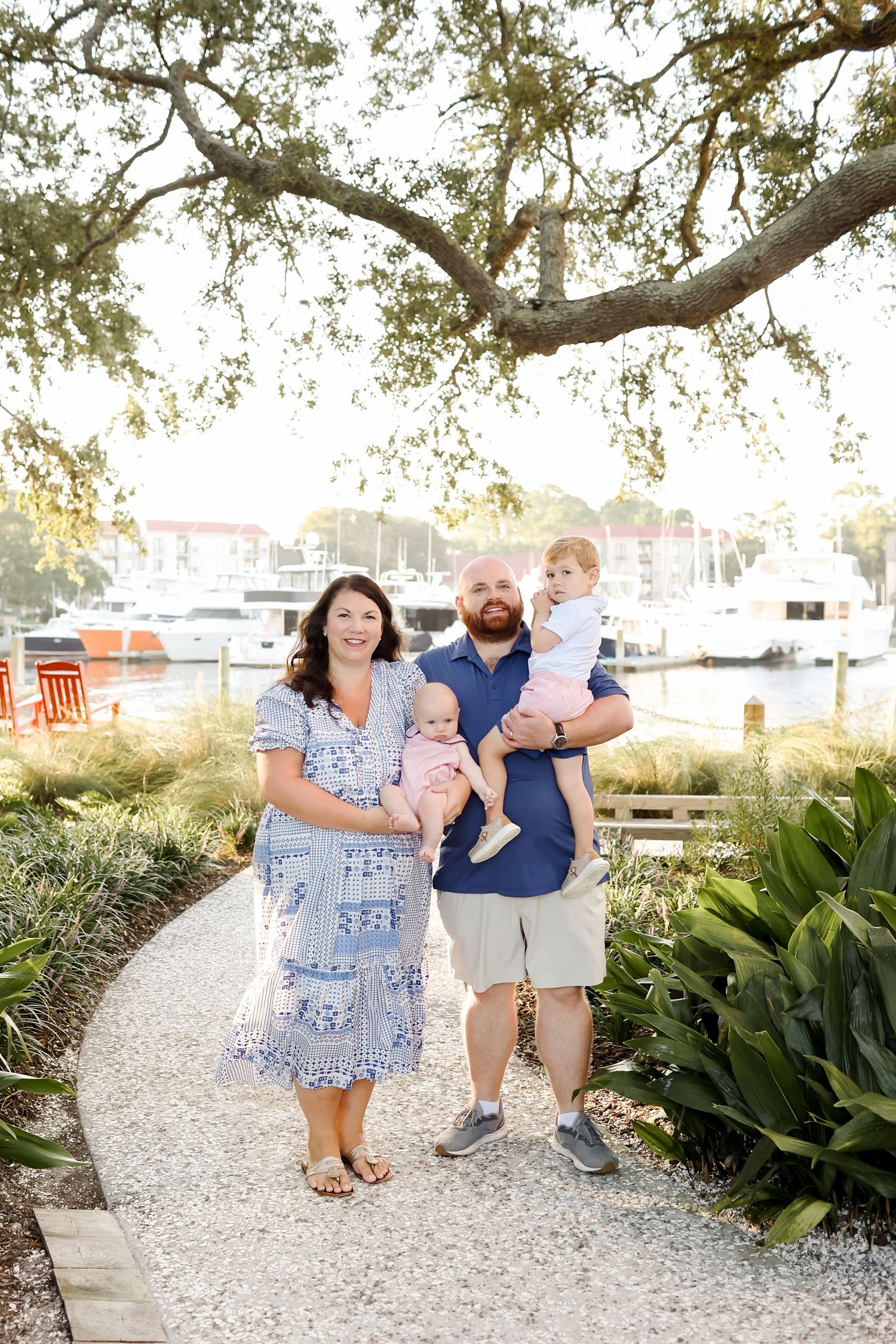 Hilton Head Island family photography with parents and two boys posing for portraits at Harbour Town in Sea Pines