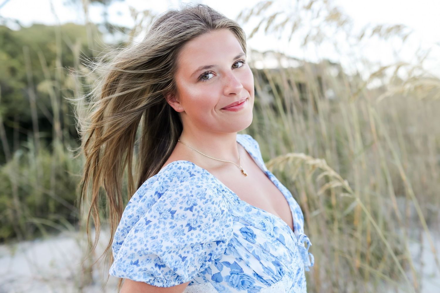 Hilton Head senior photography portrait of high school senior smiling in sand dunes at Sea Pines Beach Club