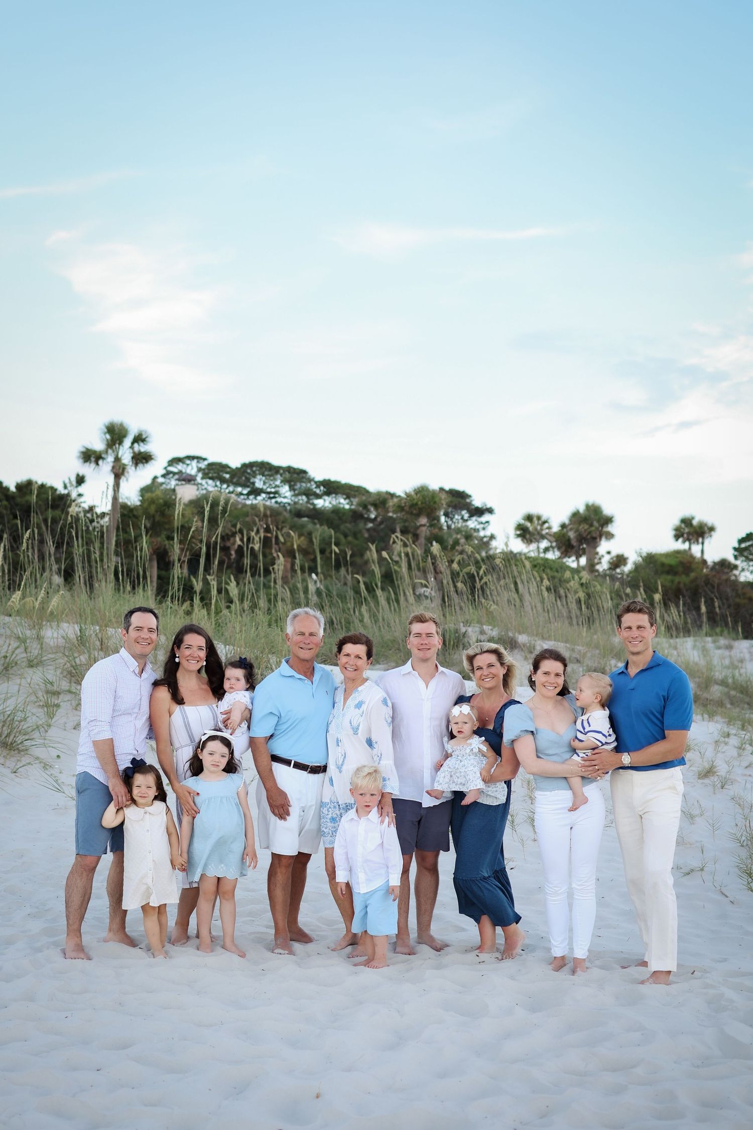 Large extended family posing for family reunion photos at Sea Pines Beach Club on Hilton Head Island, classic blue and white outfits