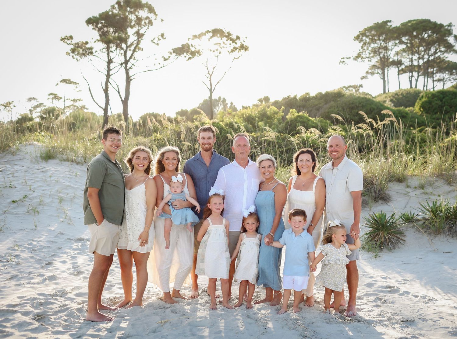 Extended family photography on Hilton Head Island with family smiling in sand dunes at Sea Pines Beach Club