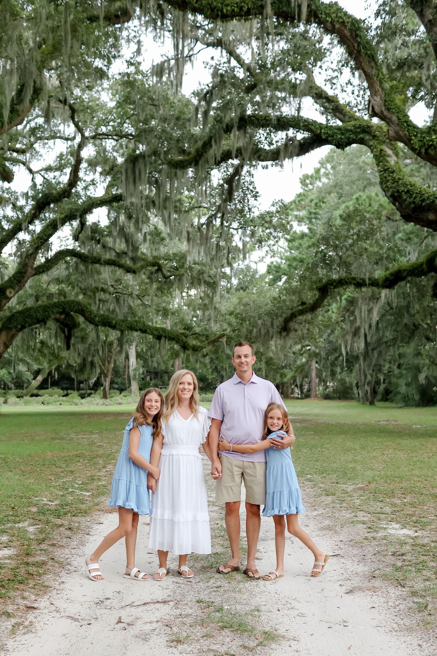 Family photography in Sea Pines on Hilton Head with parents and children smiling beneath Lowcountry oak trees