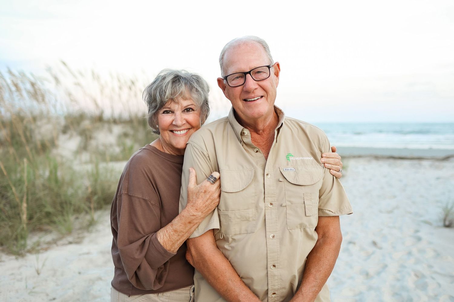 Hilton Head family photography featuring grandparents posing together in the sand dunes at Singleton Beach on Hilton Head Island