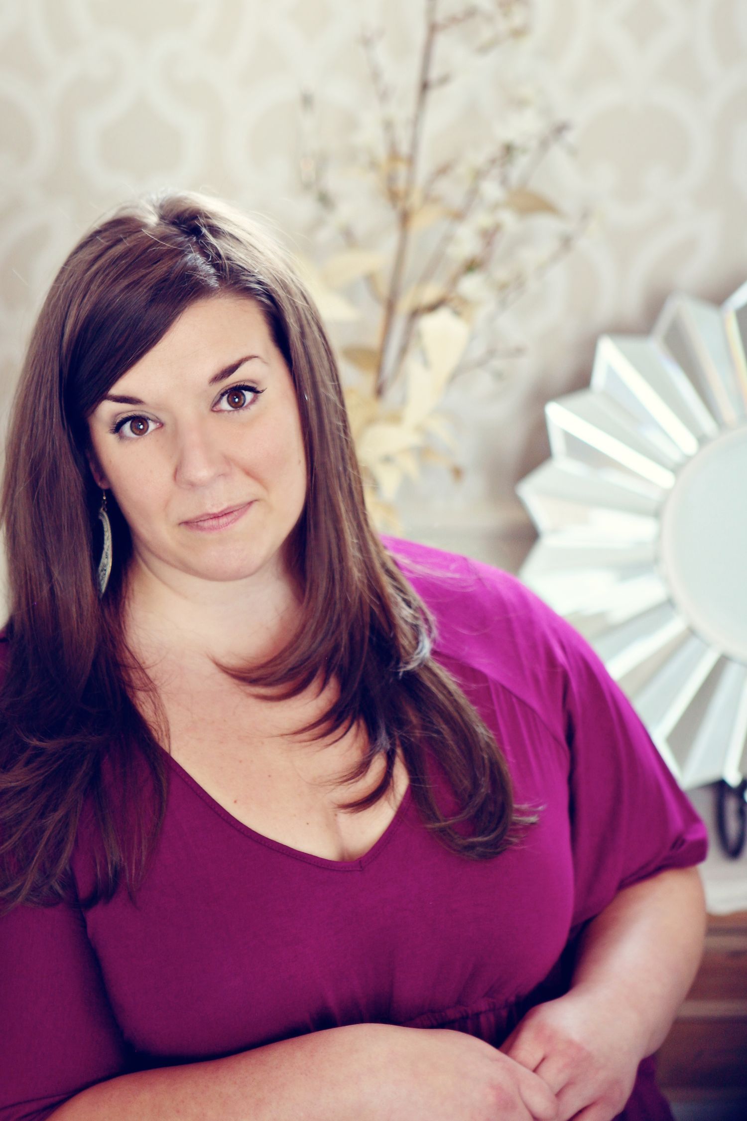 Portrait of Hilton Head photographer Krista Ercin-Maurer standing in a stairwell looking calmly at the camera