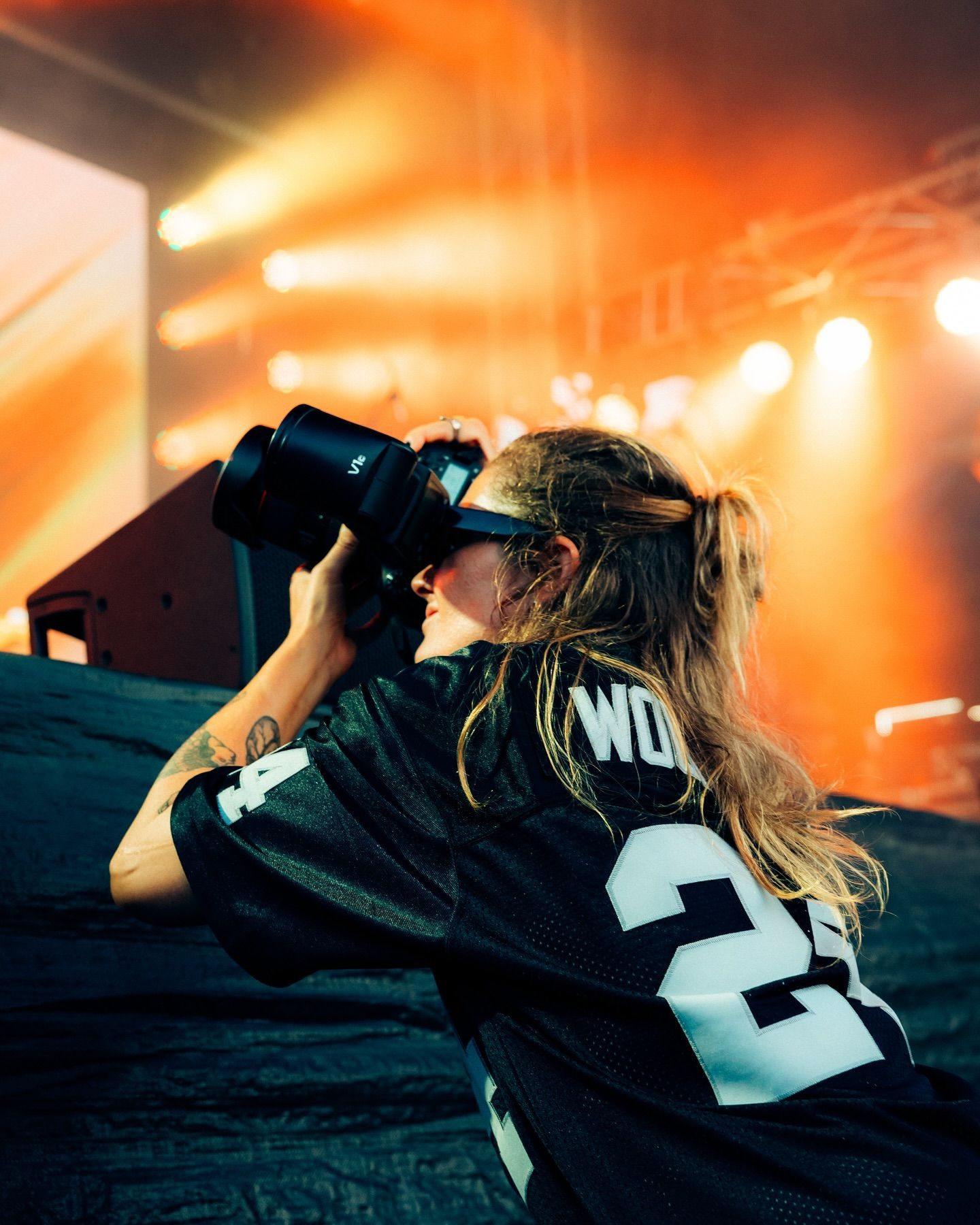 Alyse Filipuzzi, Newcastle photographer shooting Earp Over The Ditch Festival with orange stage lights.