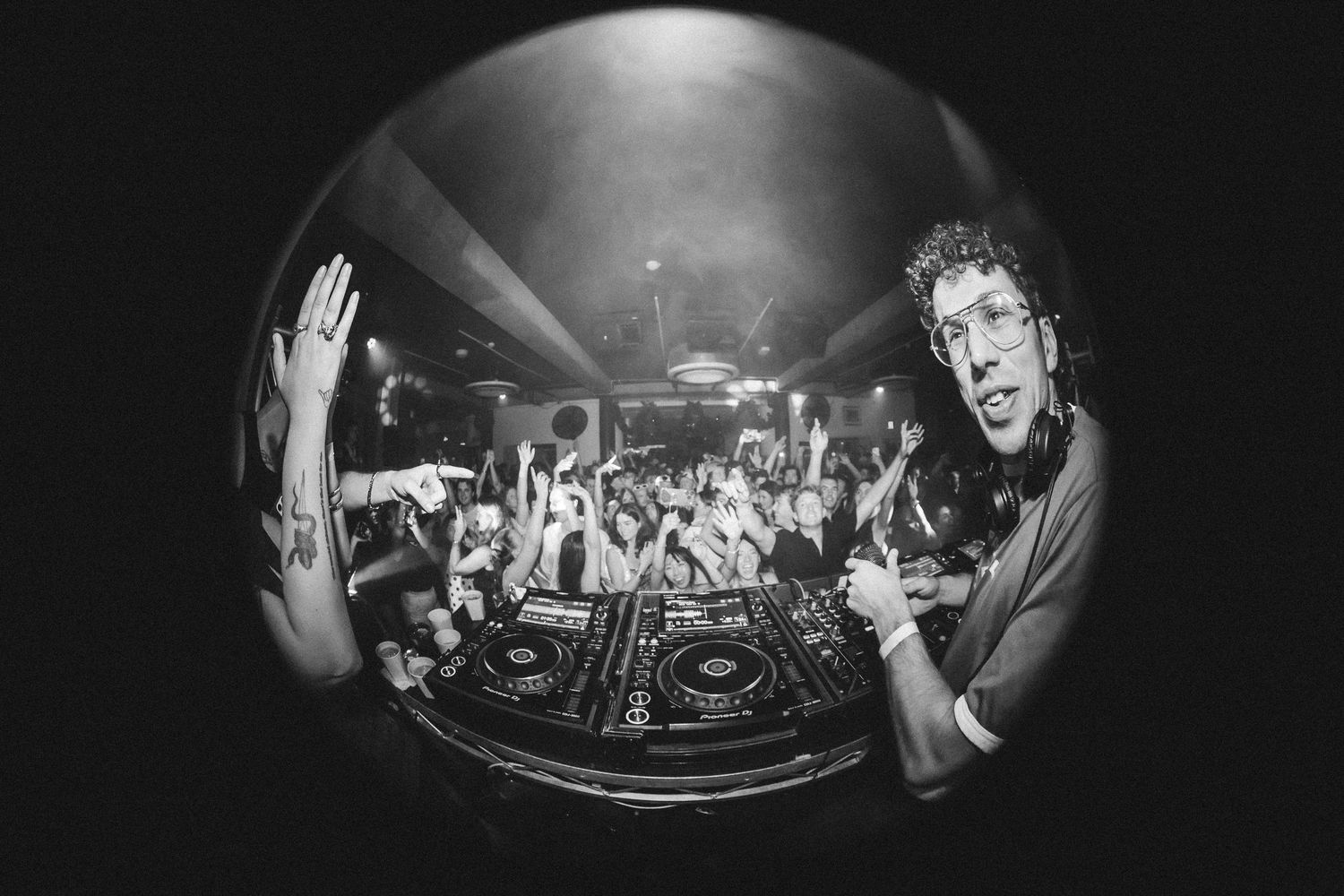 Black and white fisheye photo of Young Franco performing with  packed crowd at The Beach Hotel.