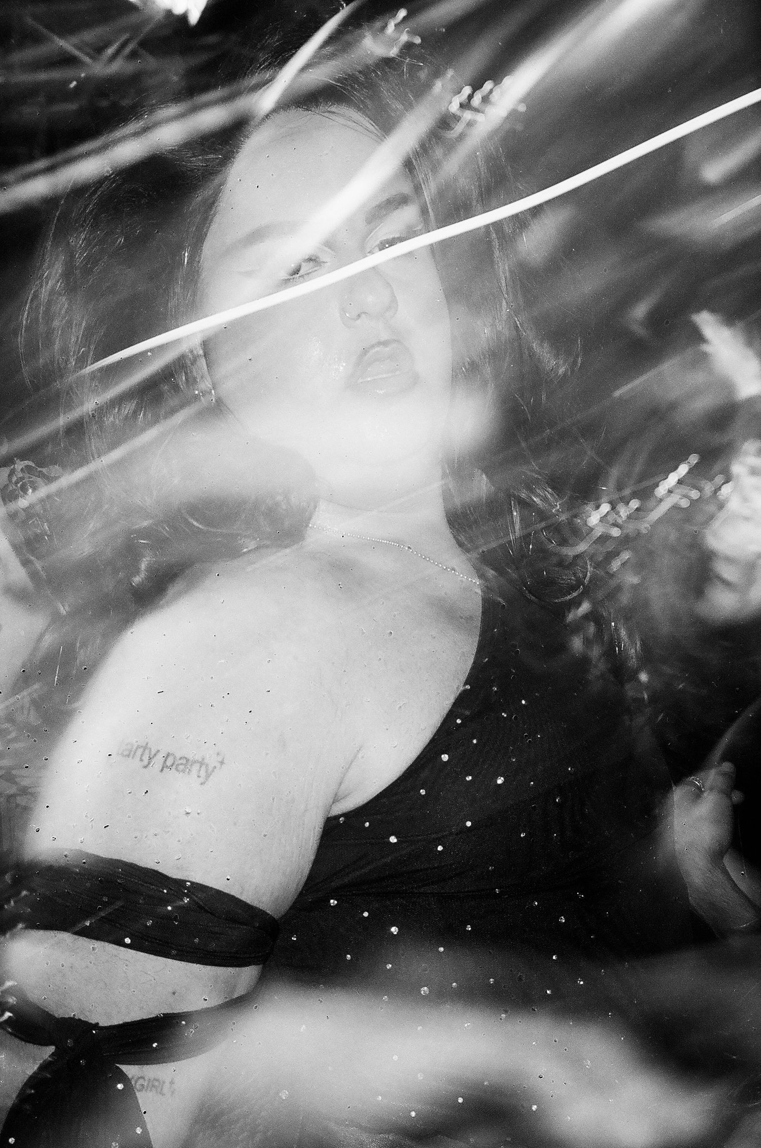 Black and white blurred artistic photo of a woman with tarty party tattoo at The Lass O'Gowrie Hotel.