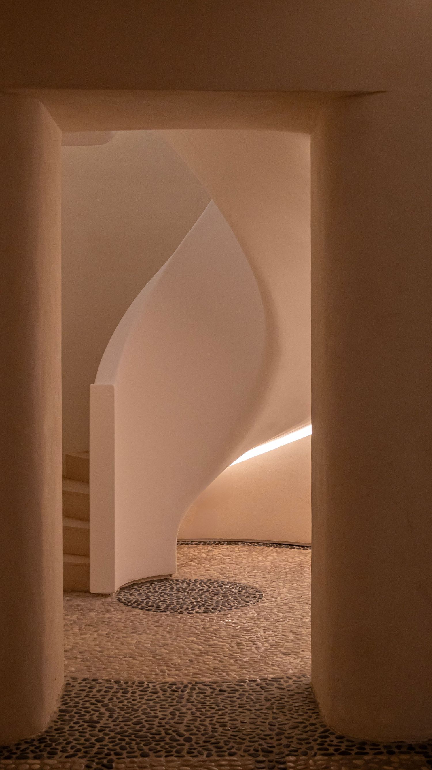 architectural turning staircase and hand-laid pebble mosaic floor