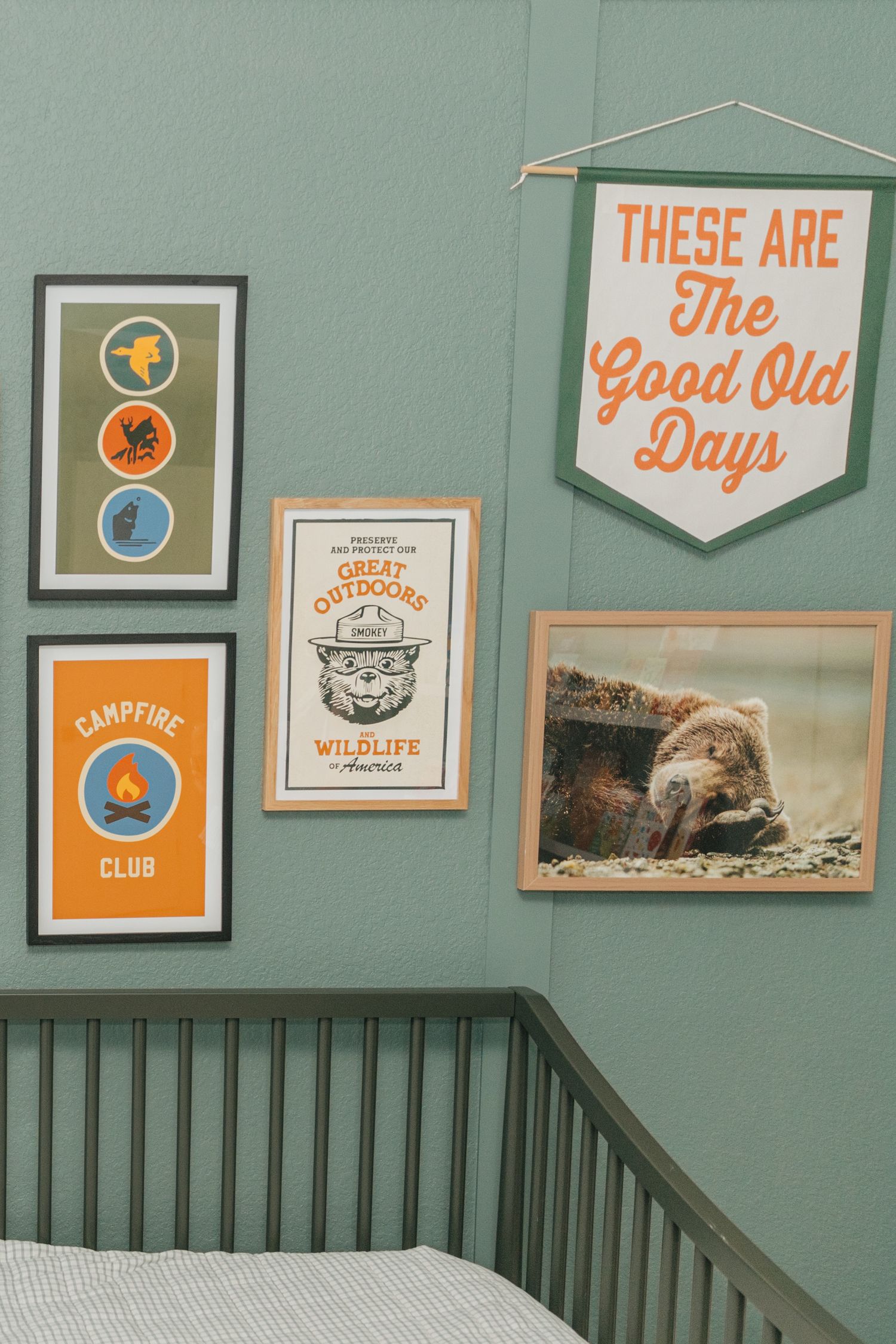 Outdoor-themed kids room gallery wall with campfire club prints and good old days banner.