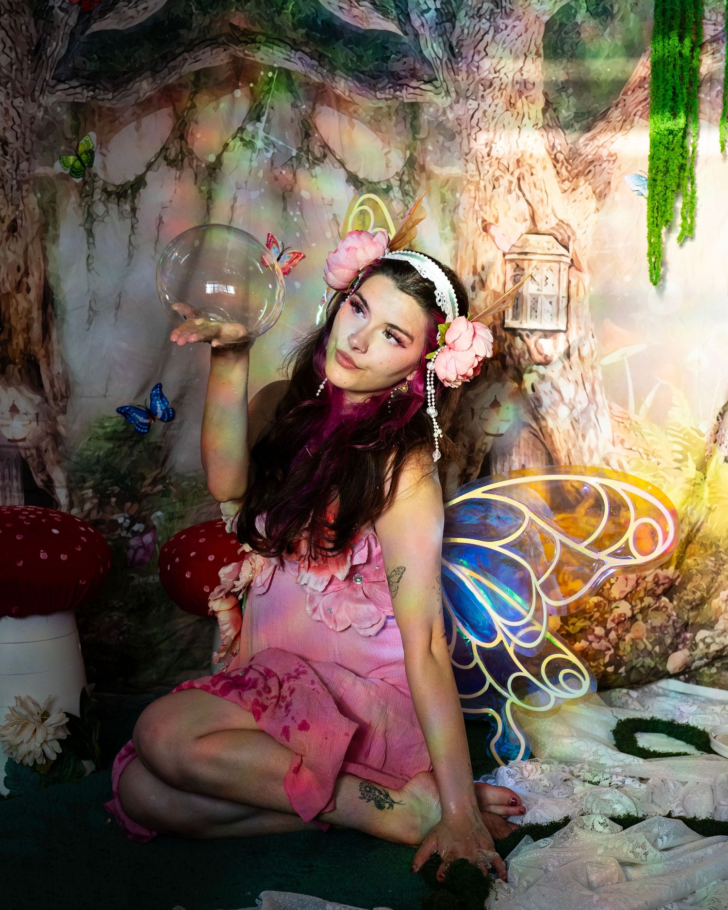 Fairy cosplay woman holding a glass orb in a magical woodland photography studio. Fantasy Photoshoot