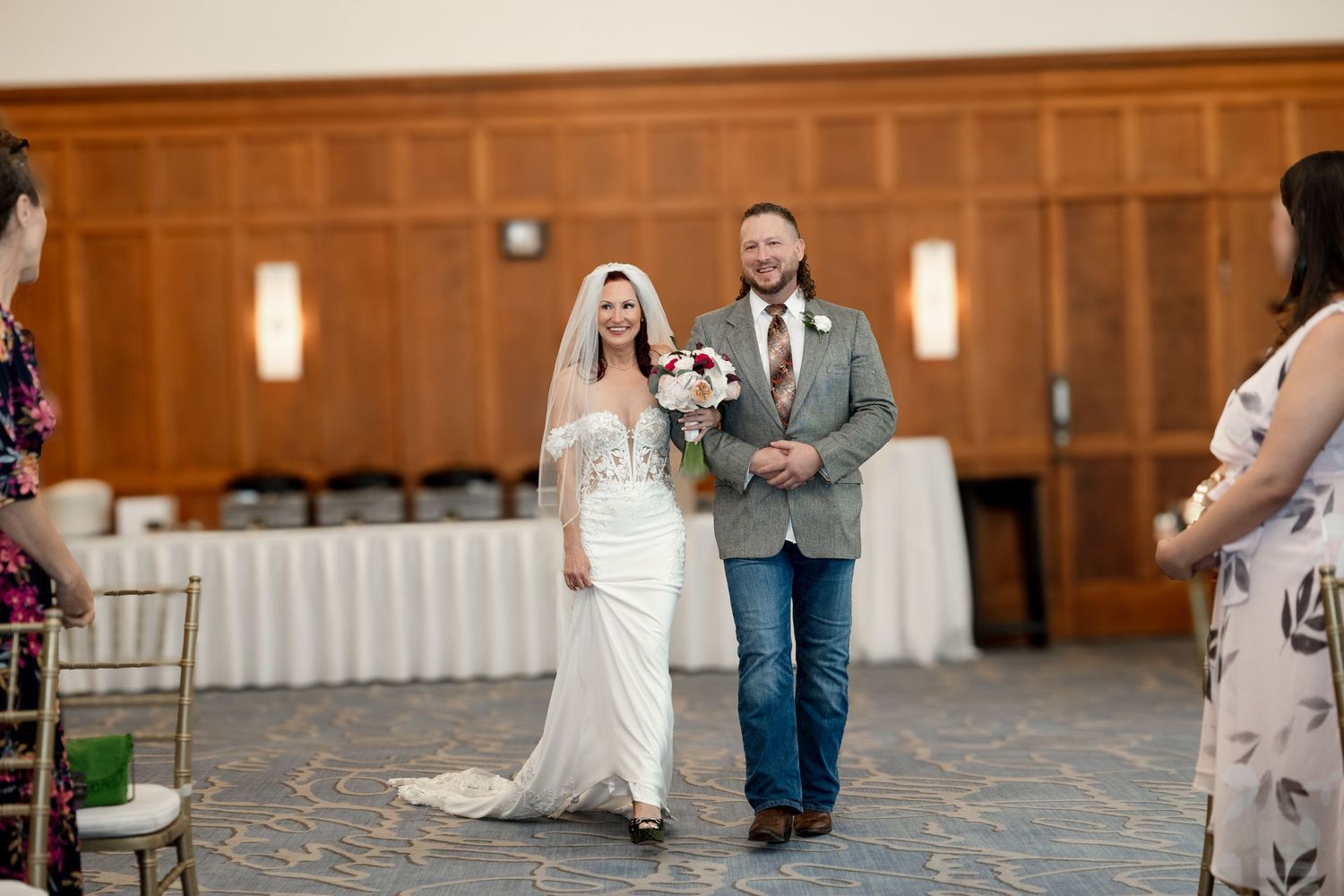 Bride  walks down aisle with escort at Le Méridien Tampa, Florida, captured by Grand Photo by Karyna Oliinyk