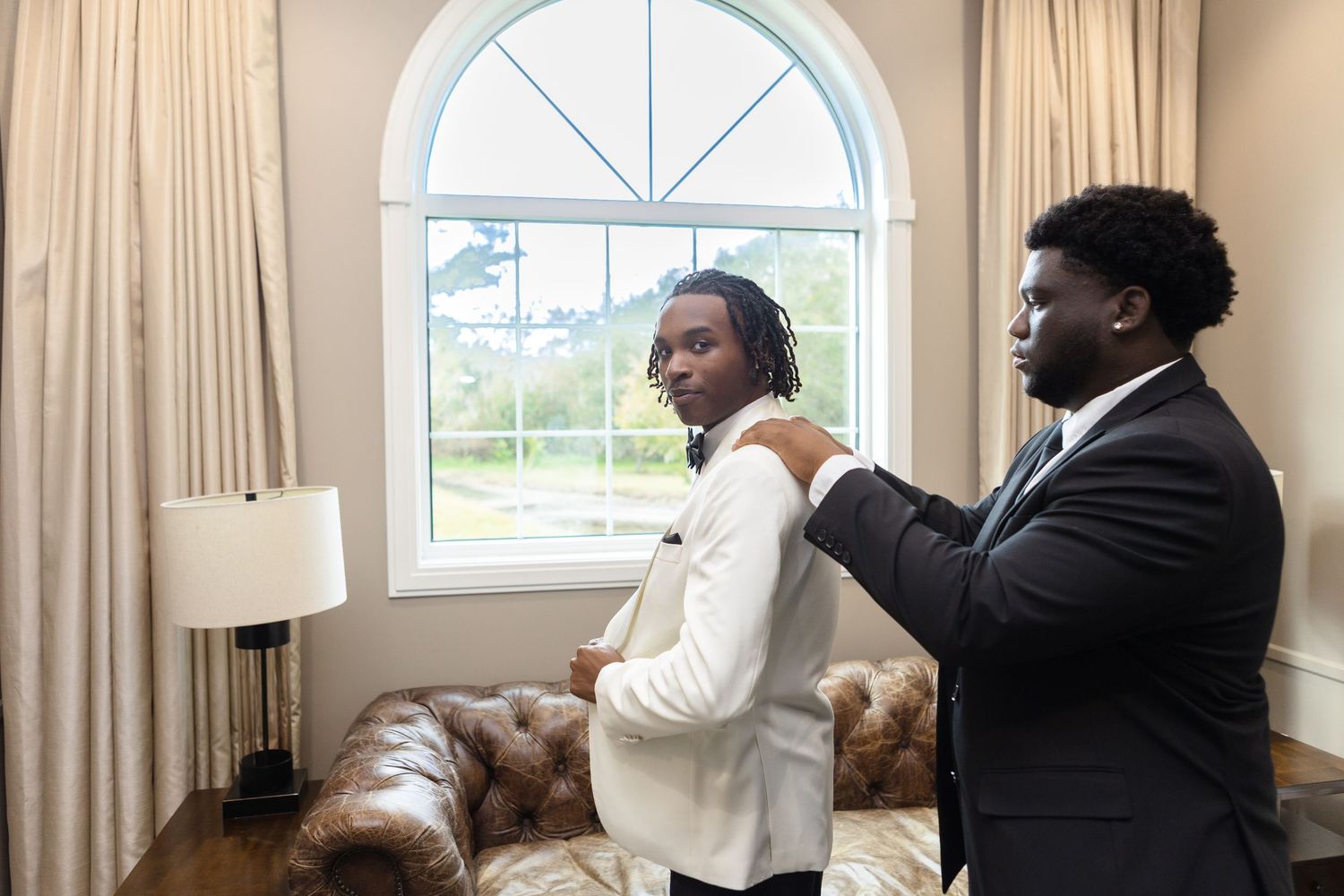 Best man helping the groom get ready at Harborside Chapel in Safety Harbor, Florida — wedding photographer Grand Photo, Karyna Oliinyk