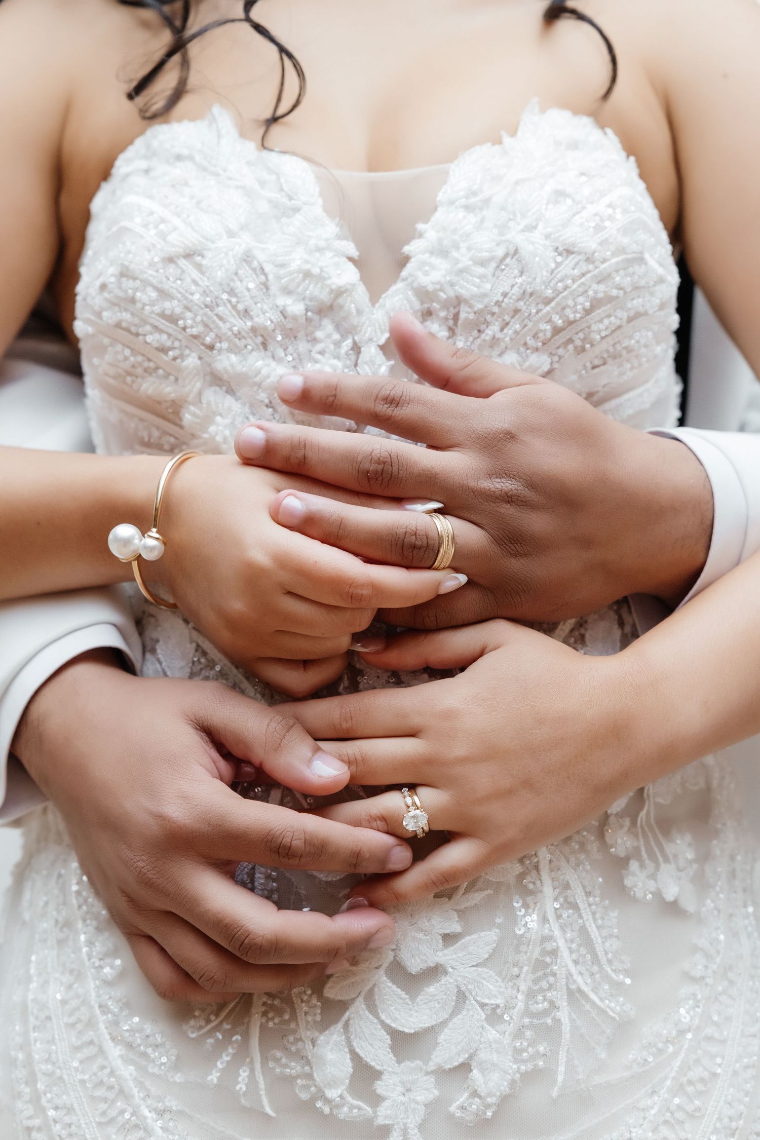 Close-up of bride and groom hands with gold rings on lace dress at Vinoy St. Petersburg FL, wedding photographer Grand Photo Karyna Oliinyk