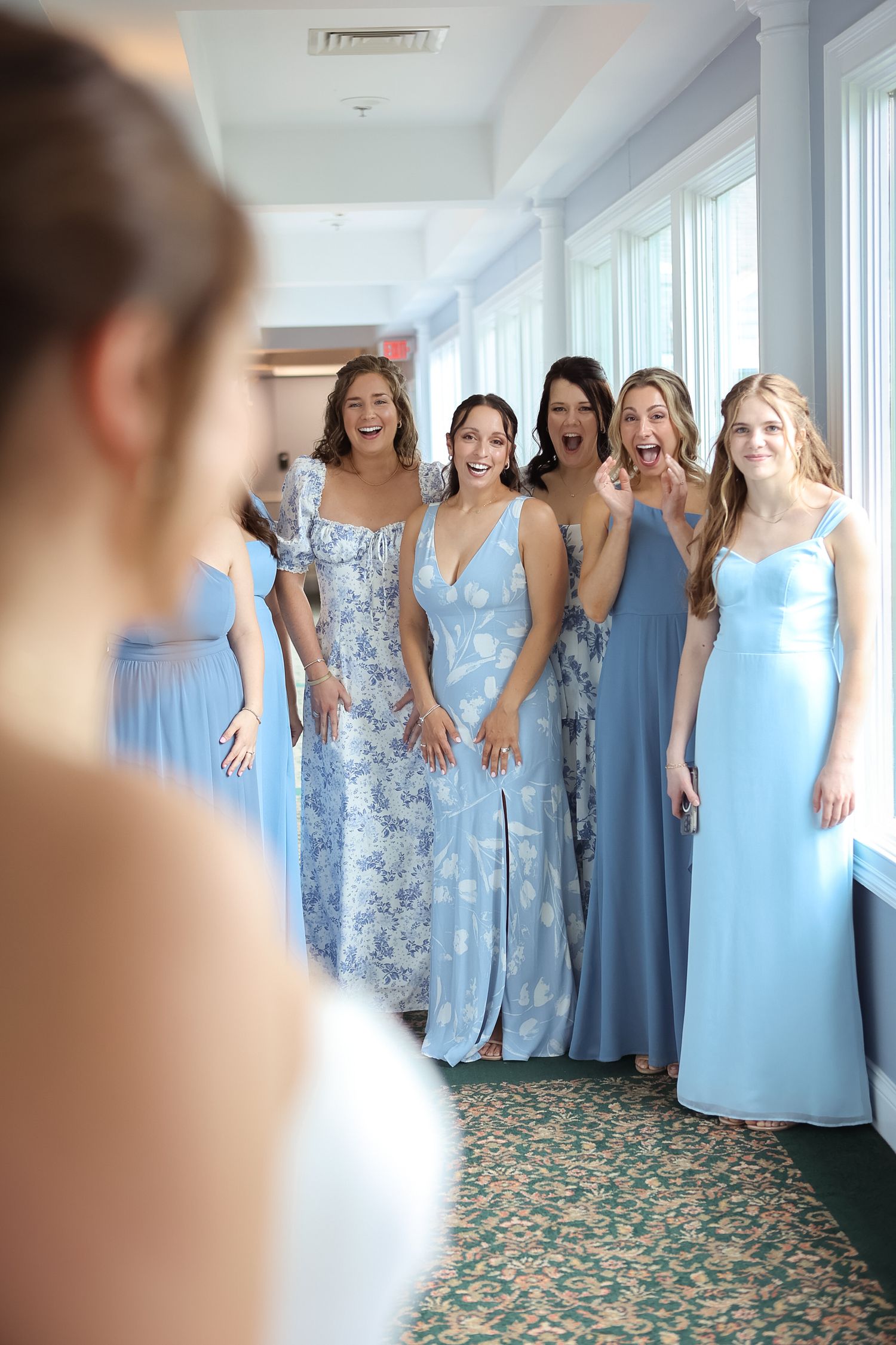 Bridesmaids first look with bride at Clear Sky Beachside Cafe Events in Clearwater Beach, Florida, captured by Grand Photo by Karyna Oliinyk