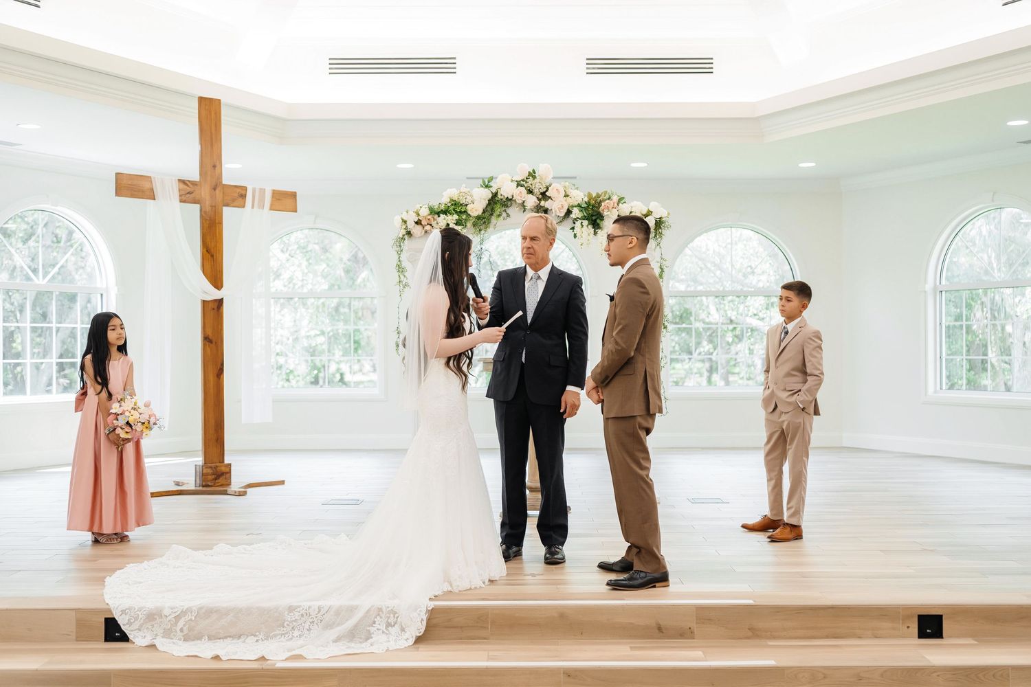 Bride and groom exchanging vows during the  ceremony at Harborside Chapel in Safety Harbor —wedding photographer Grand Photo, Karyna Oliinyk