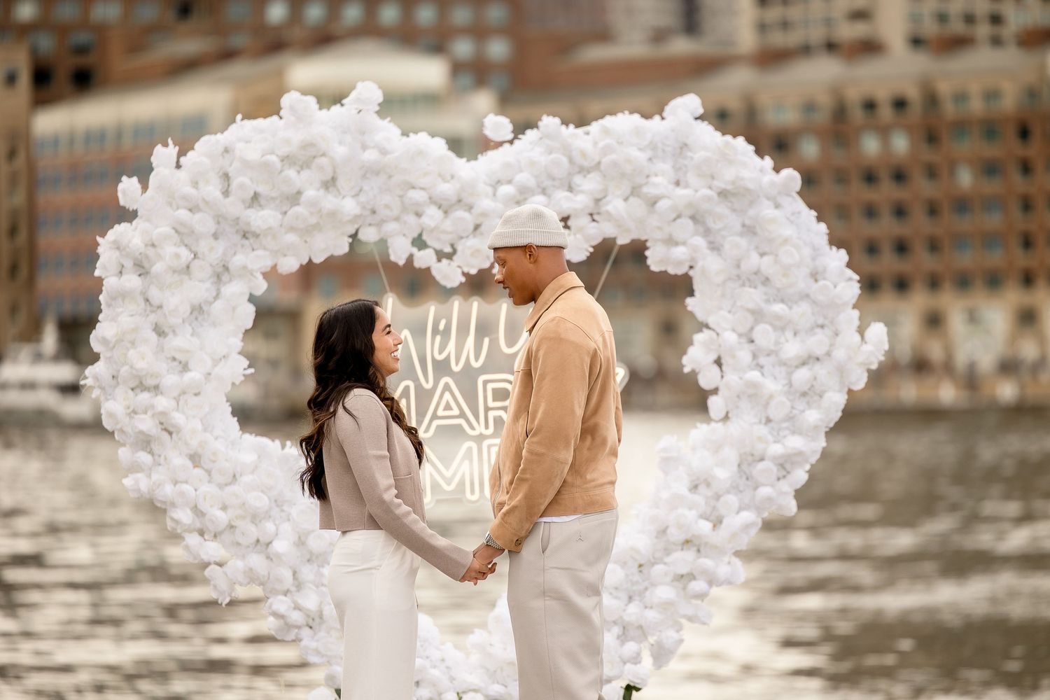 Surprise proposal session with a white heart arch in Seaport Boston Massachusetts, captured by Grand Photo, Karyna Oliinyk
