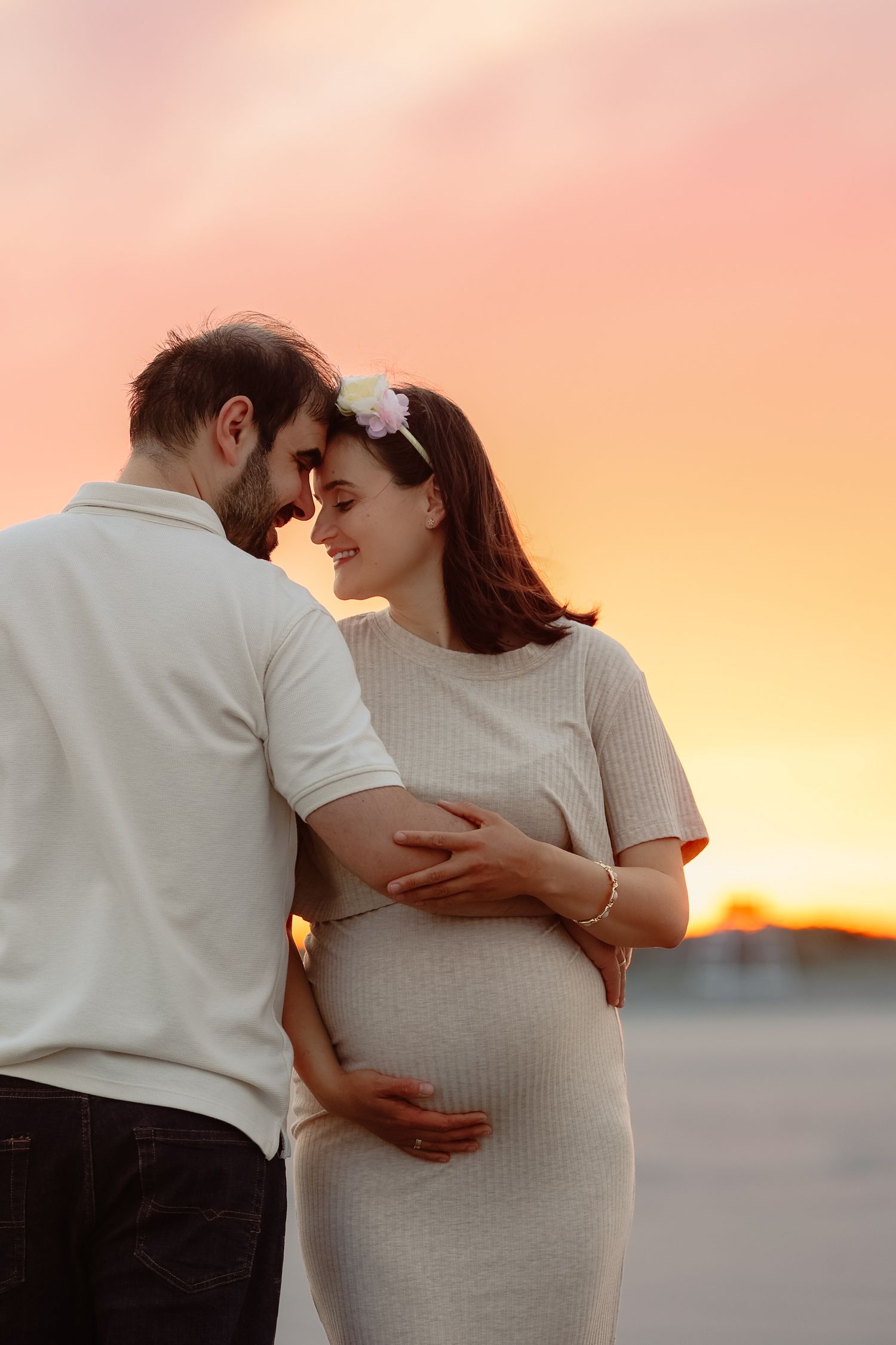 Romantic pregnant couple embracing at sunset at Lido Beach Sarasota FL, maternity photographer Grand Photo Karyna Oliinyk
