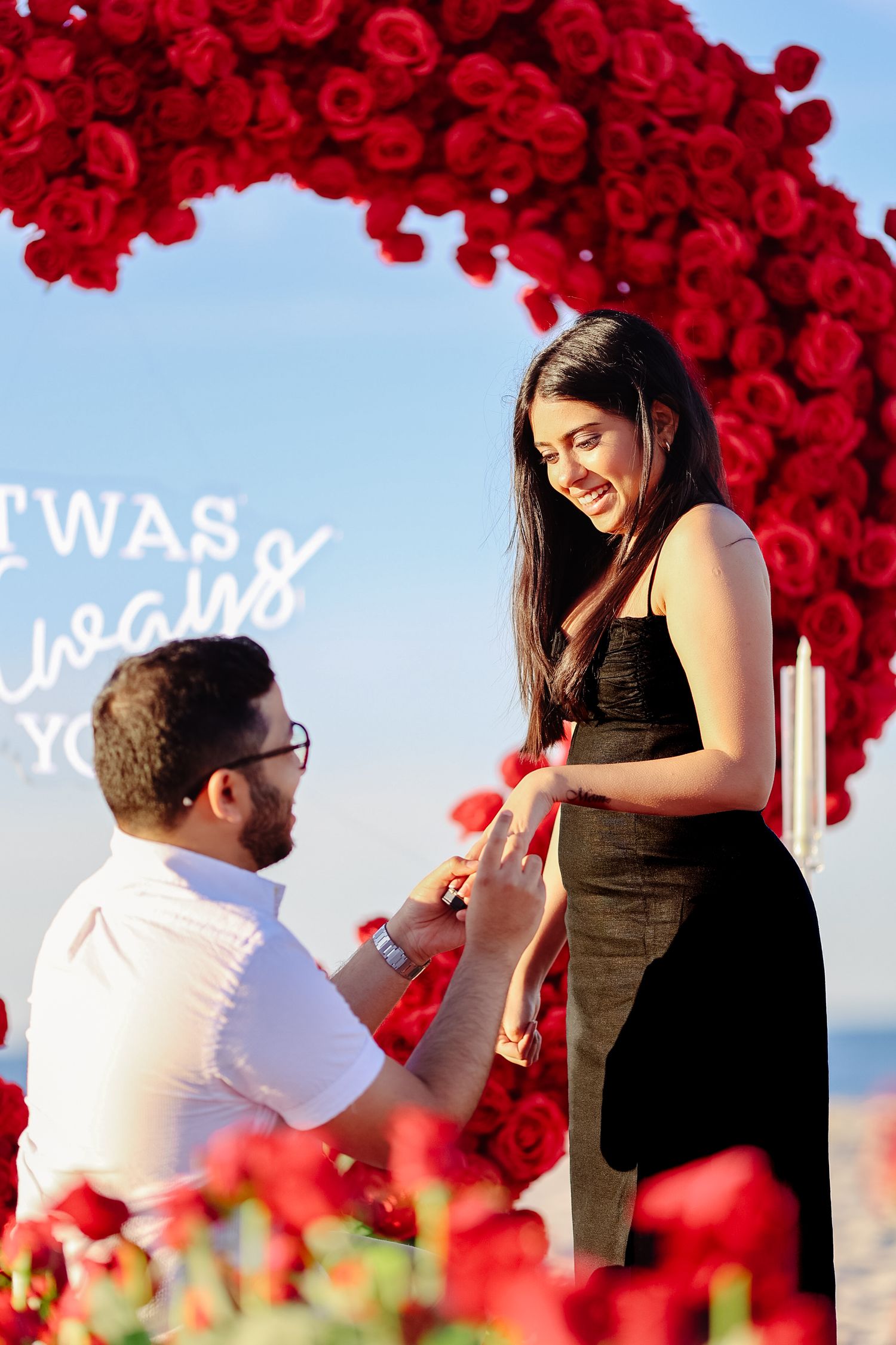 Surprise sunset beach proposal session with a red heart arch in Boston Massachusetts, captured by Grand Photo, Karyna Oliinyk