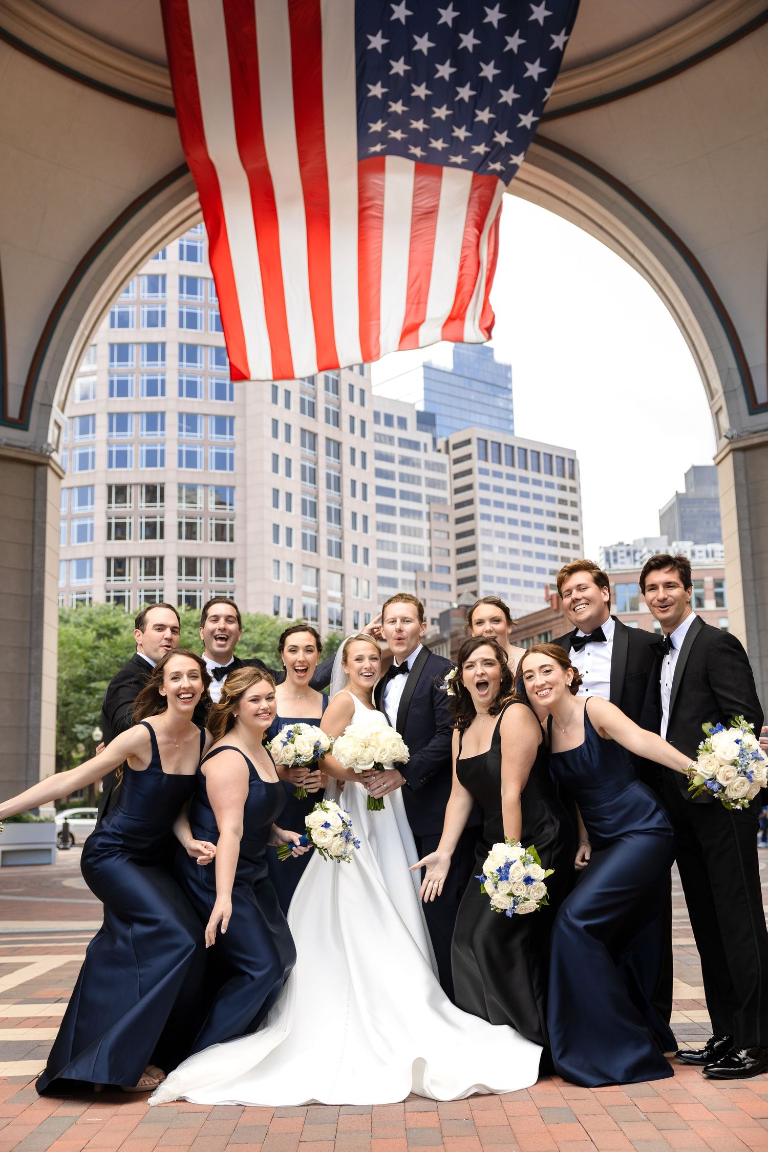 Wedding party celebrating with bride and groom at Boston Harbor Hotel in Boston, Massachusetts, captured by Grand Photo by Karyna Oliinyk