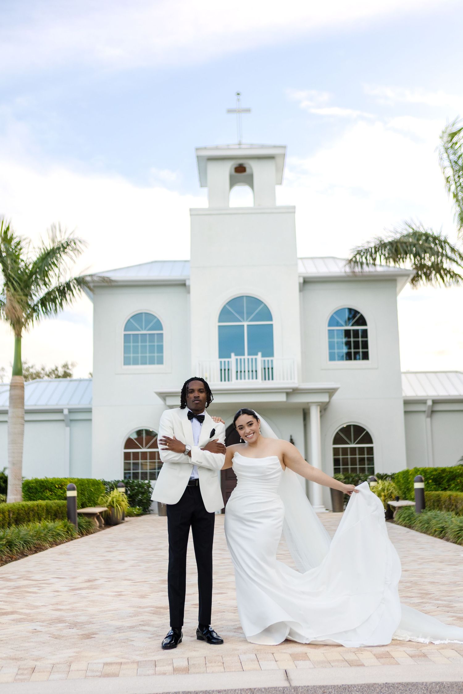 International bride and groom dancing outside Harborside Chapel in Safety Harbor, Florida — wedding photographer Grand Photo, Karyna Oliinyk