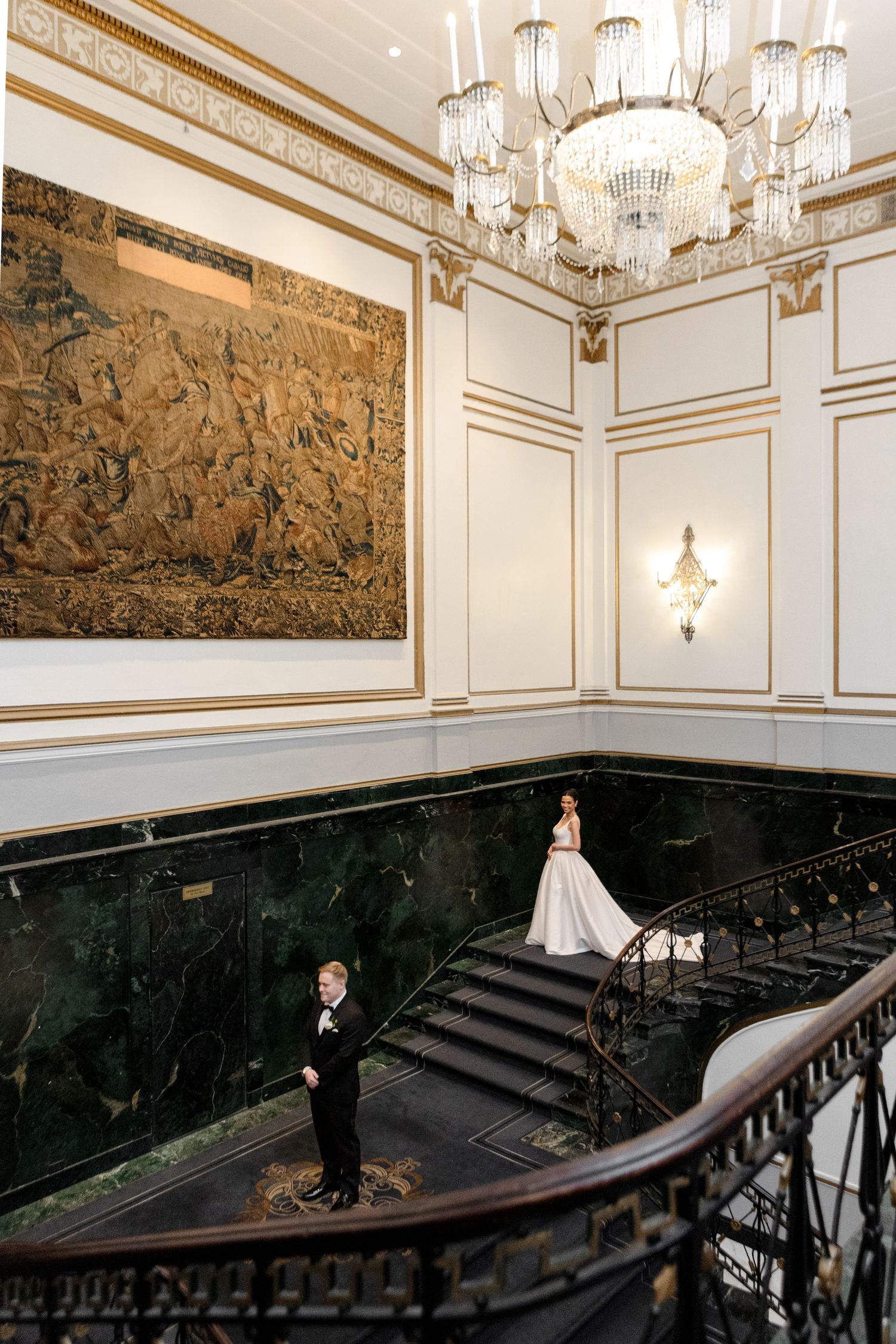 Bride and groom on grand staircase at Hilton in Tampa, Florida, wedding photographer Grand Photo
