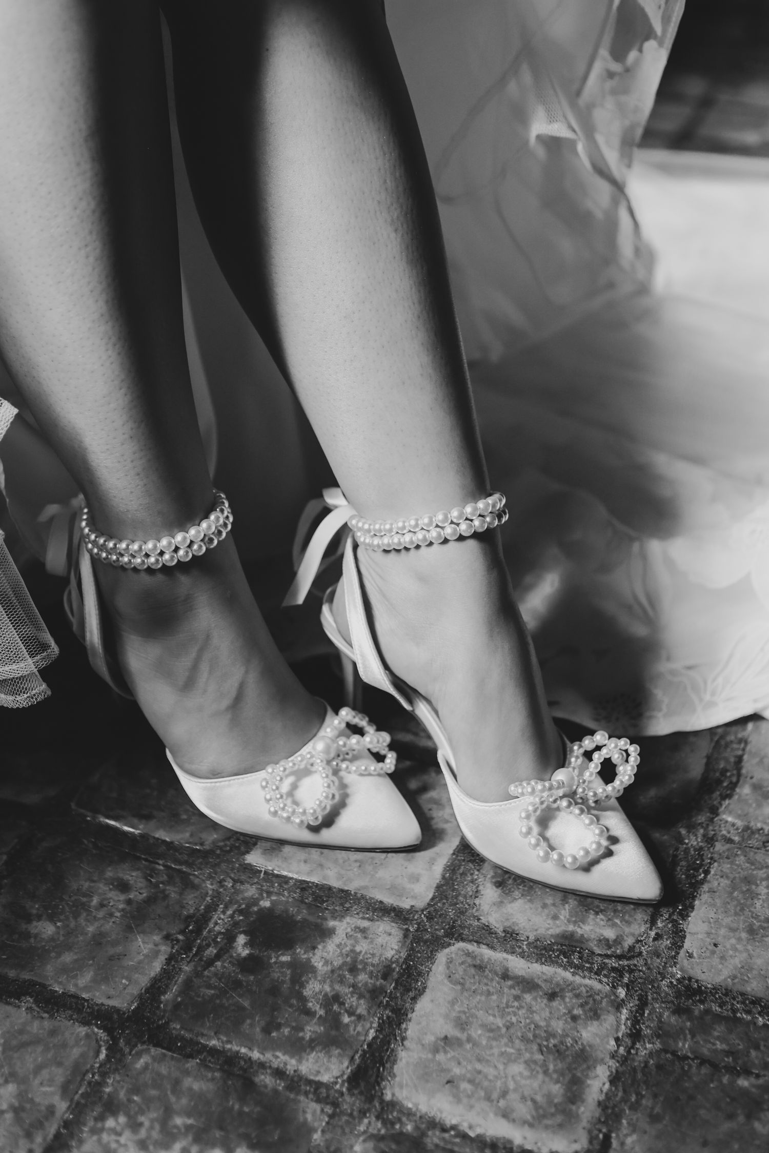 Elegant white heels with pearl ankle strap at The Birchwood in St. Petersburg, Florida, captured by Grand Photo by Karyna Oliinyk