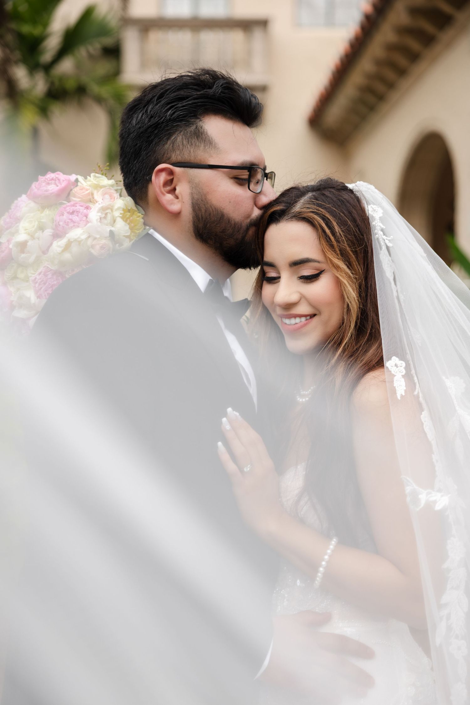 Bride and groom portraits with flowing veil at Powel Crosley Estate in Sarasota, Florida, captured by Grand Photo by Karyna Oliinyk