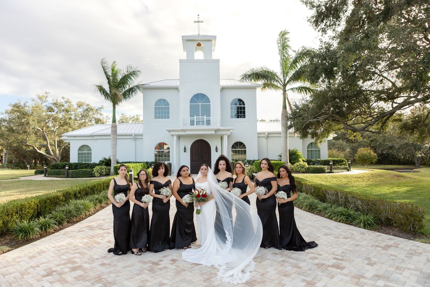 Bride with bridesmaids outside Harborside Chapel in Safety Harbor, Florida — wedding photographer Grand Photo, Karyna Oliinyk