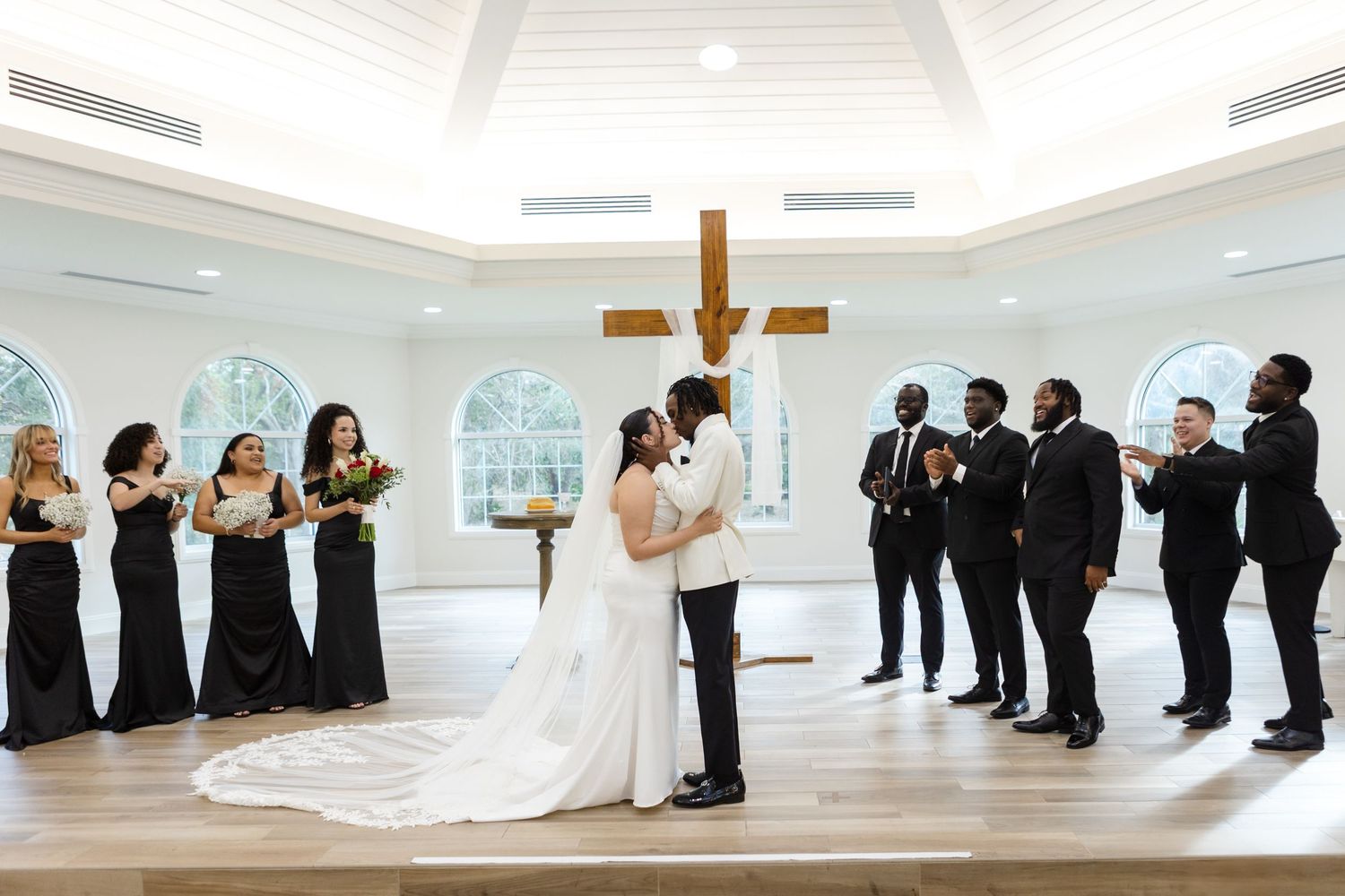 Bride and groom’s first kiss during the wedding ceremony at Harborside Chapel in Safety Harbor, Florida — wedding photographer Grand Photo
