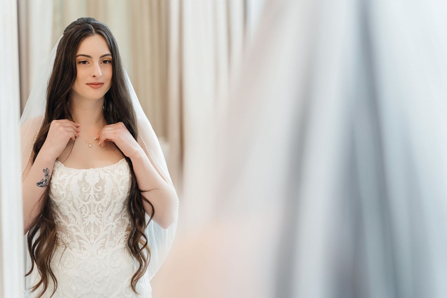 Bride putting on her necklace at Harborside Chapel in Safety Harbor, Florida — wedding photographer Grand Photo, Karyna Oliinyk