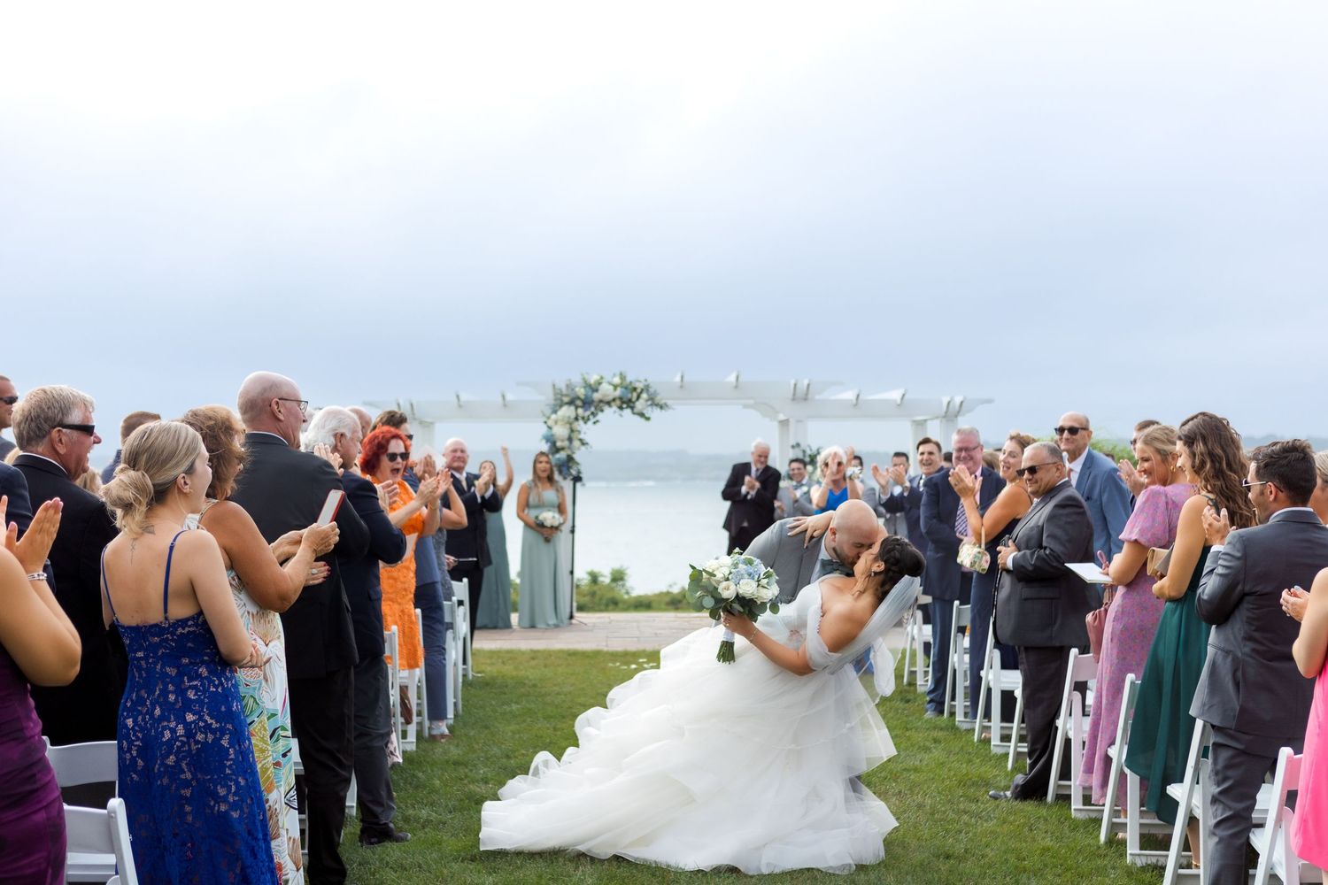 Bride and groom dip kiss during ceremony at OceanCliff Hotel Newport RI, wedding photographer Grand Photo Karyna Oliinyk