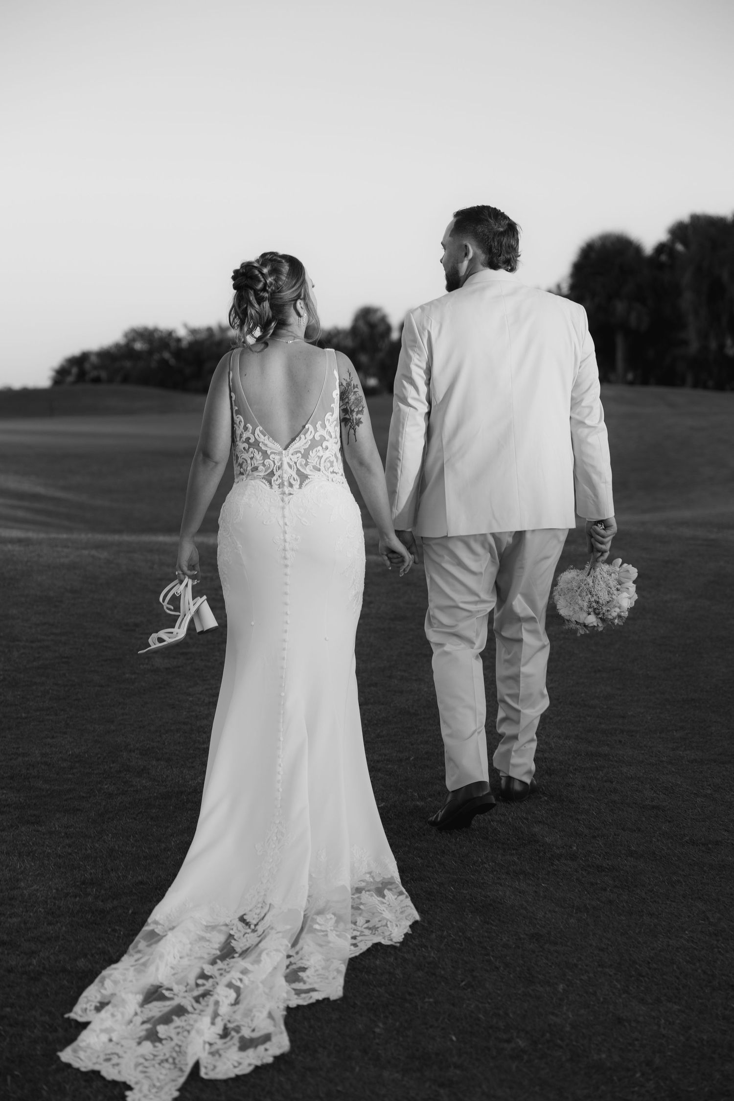 Bride and groom walking hand in hand at The Ringling in Sarasota, Florida, captured by Grand Photo by Karyna Oliinyk
