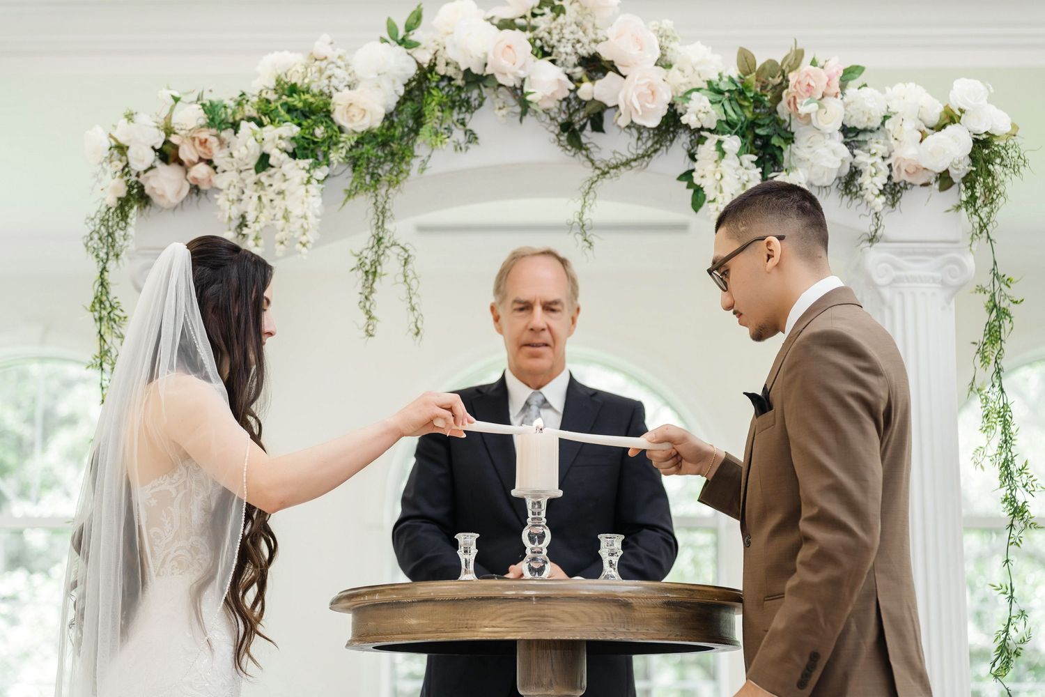 Bride and groom lighting a unity candle at Harborside Chapel in Safety Harbor, Florida — wedding photographer Grand Photo, Karyna Oliinyk