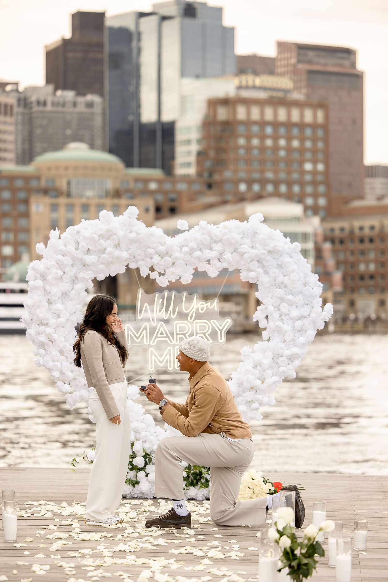 Surprise proposal session with a white heart arch in Seaport Boston Massachusetts, captured by Grand Photo, Karyna Oliinyk