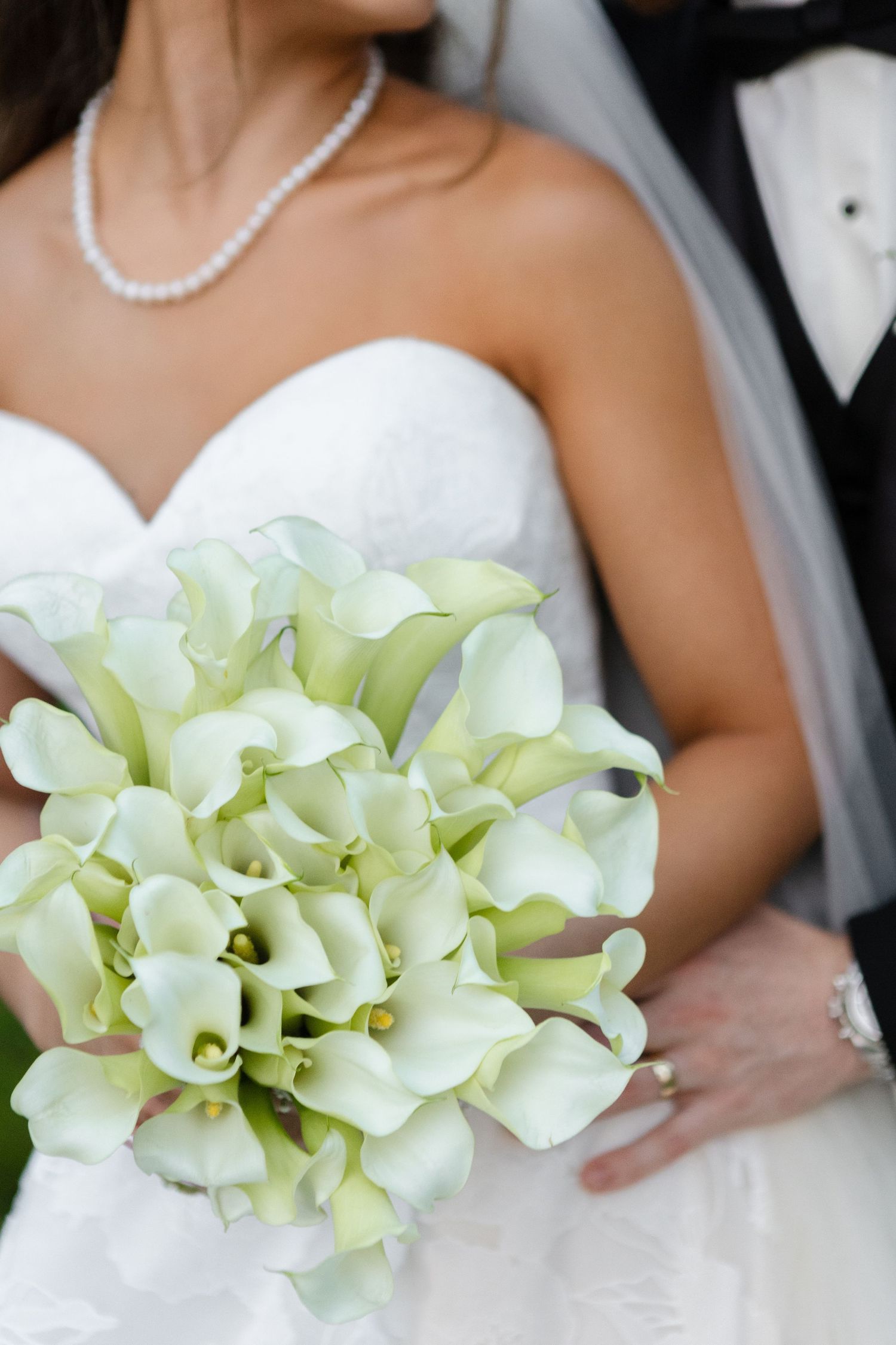 Elegant white calla lily bridal bouquet at The Westin Sarasota in Sarasota, Florida, captured by Grand Photo by Karyna Oliinyk