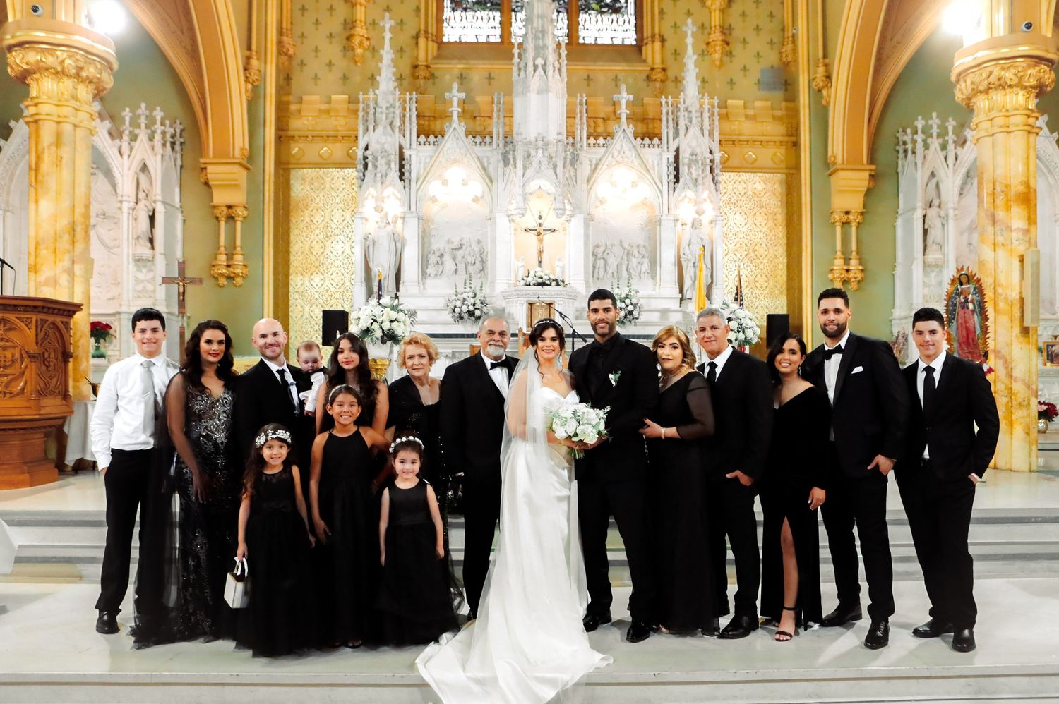 Wedding party in black attire with bride and groom in cathedral church in Tampa, captured by Grand Photo by Karyna Oliinyk